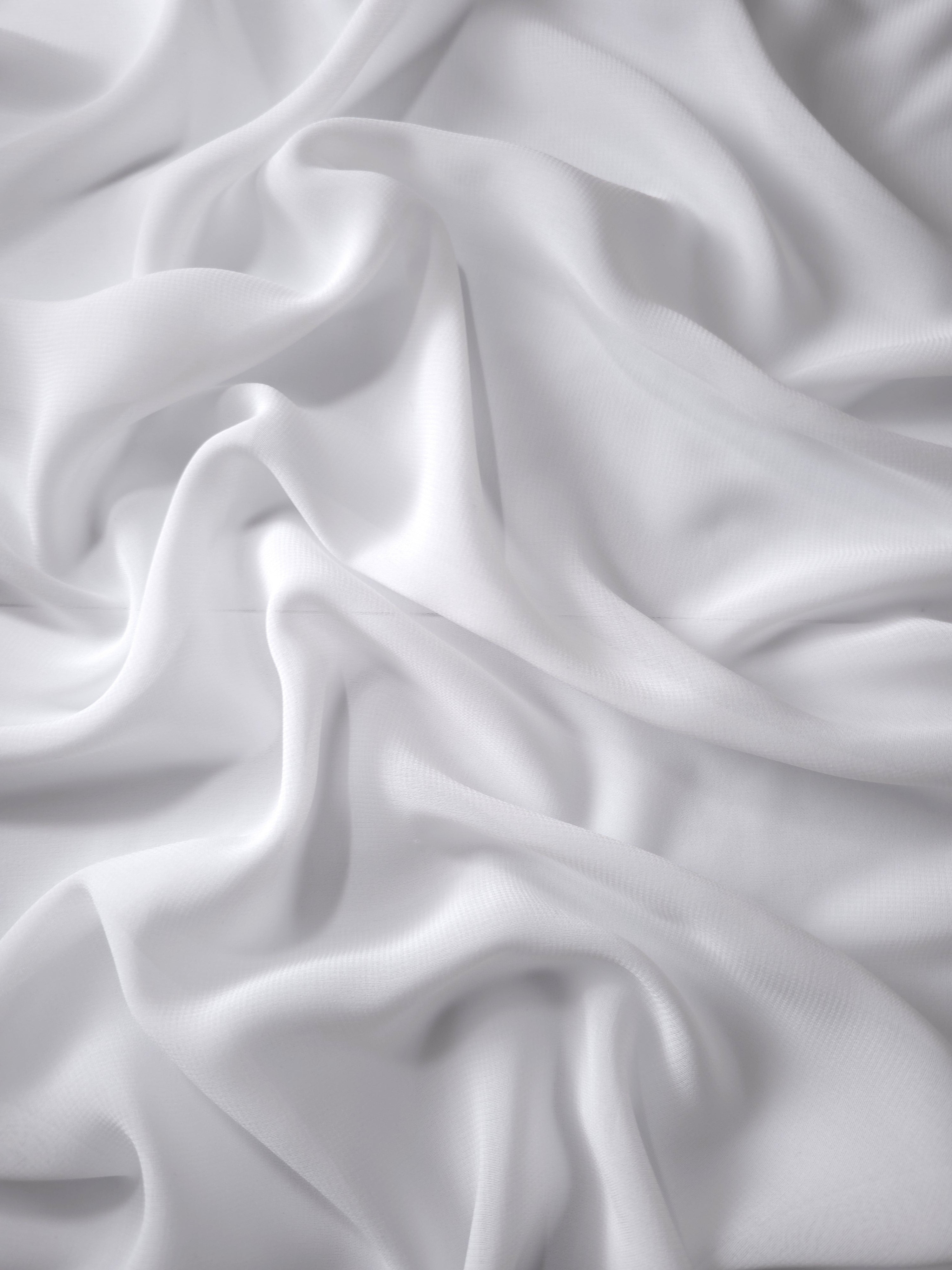 Optic White silky stretch chiffon softly folded to display drape suited to bridal dresses, scarves and soft layered tops.