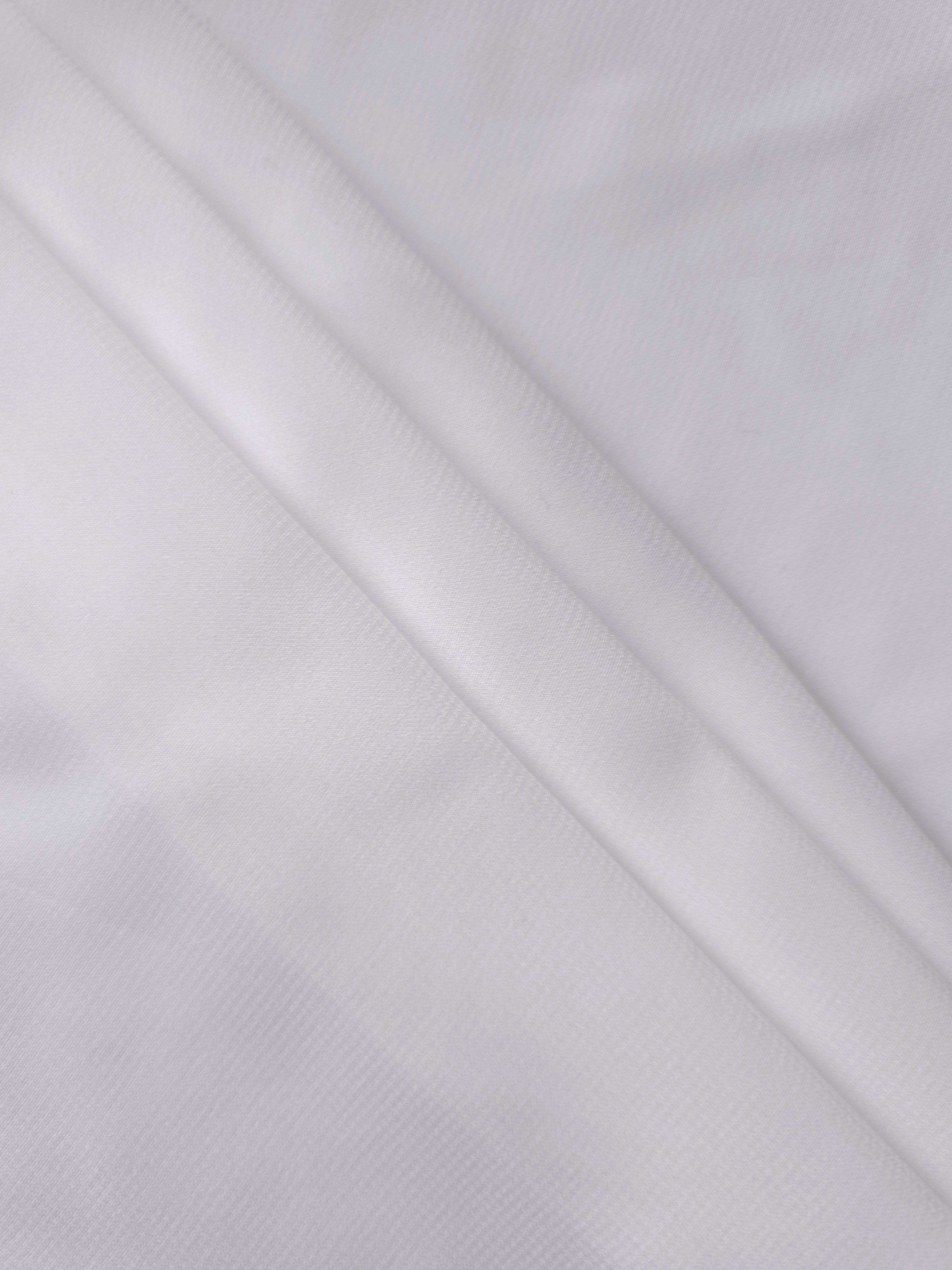 Optic White silky chiffon stretch fabric styled in a swirl to demonstrate movement for veils, shawls and gathered bridal dress layers.