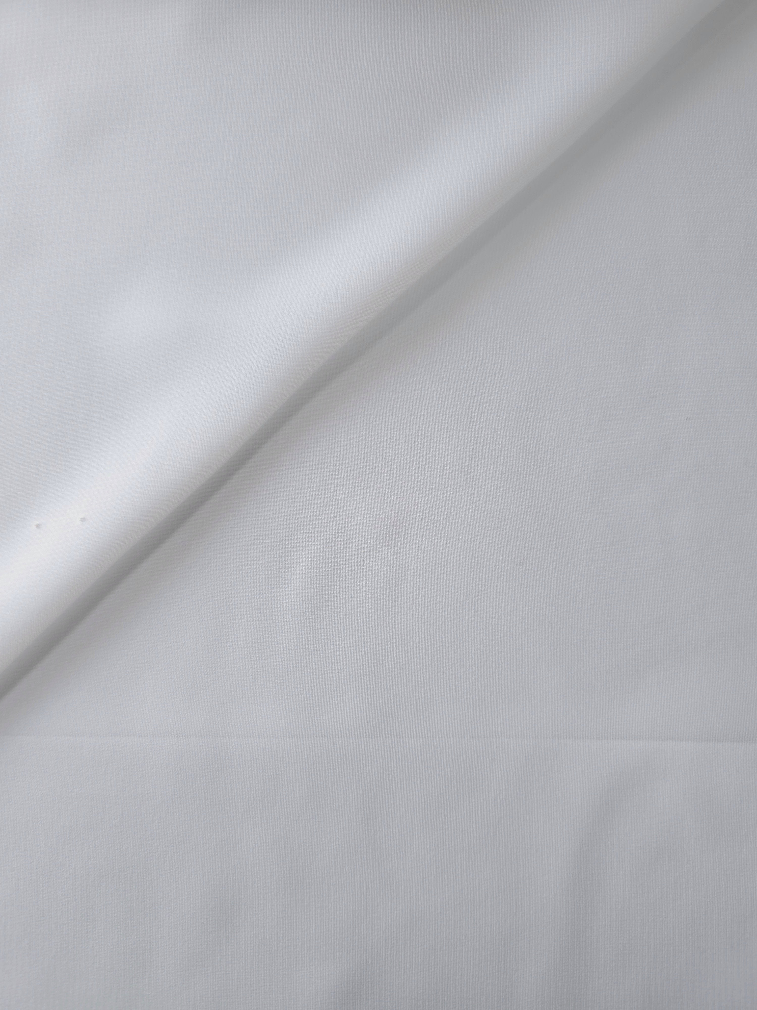 Optic White stretch chiffon in overlapping folds, showing dimensional drape for tiered skirts, bridal capelets and lined formal dresses.