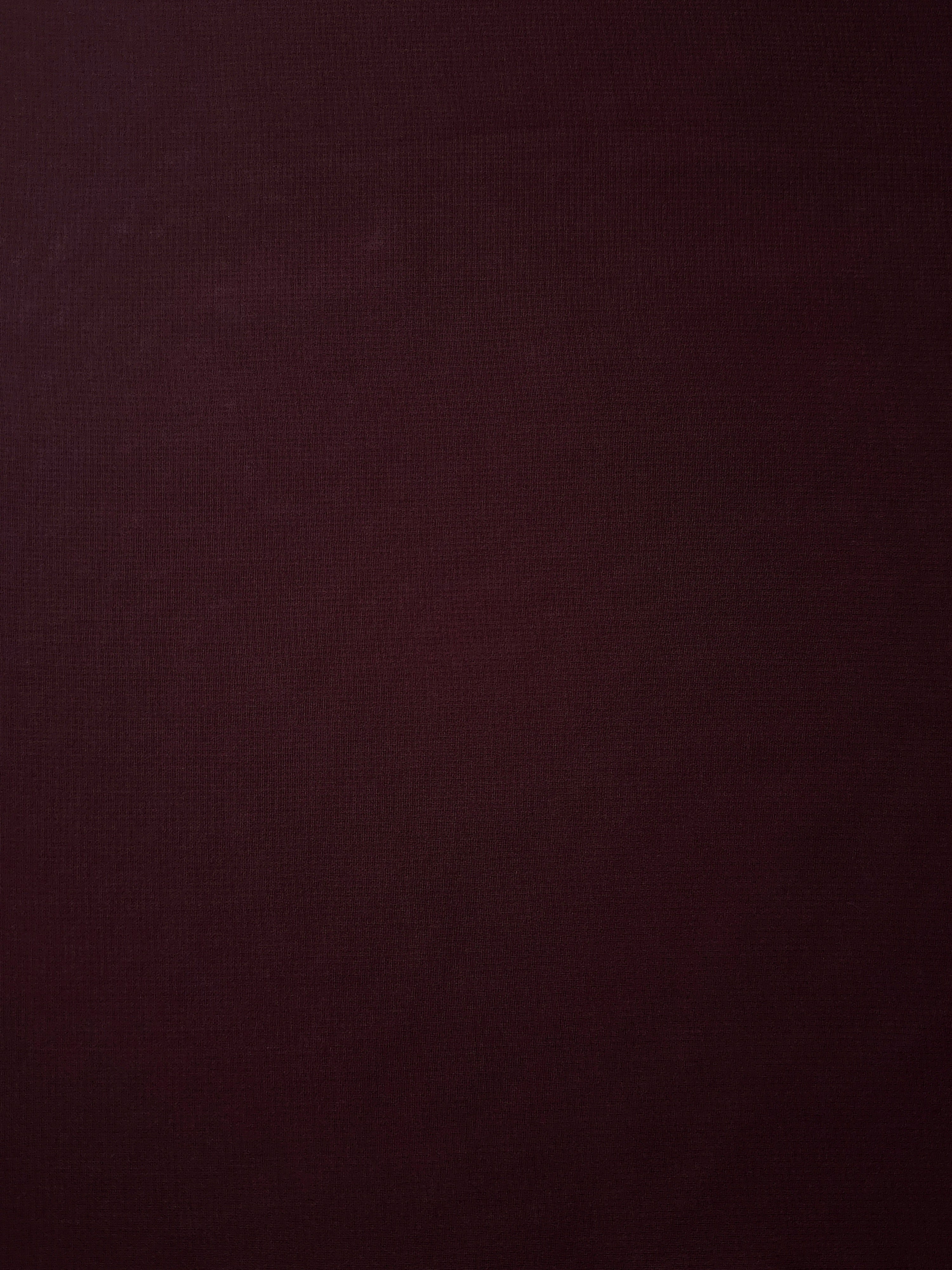 Oxblood Burgundy stretch chiffon fabric in a full surface view, with soft transparency for evening blouses, formal skirts and dramatic dress overlays.
