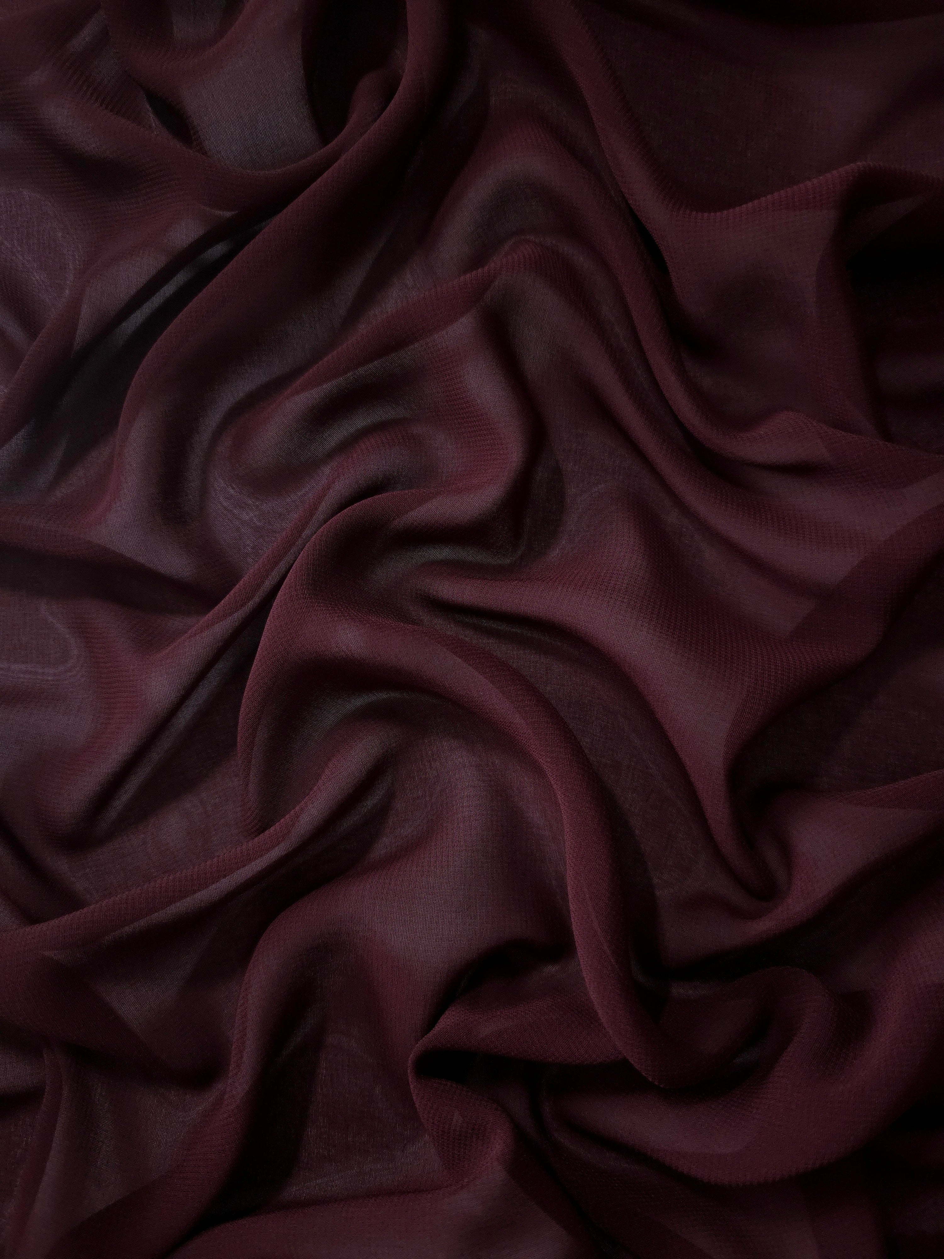 Flowing folds of Oxblood Burgundy stretch chiffon highlight its elegant drape for gowns, cocktail dresses and flowing occasion skirts.