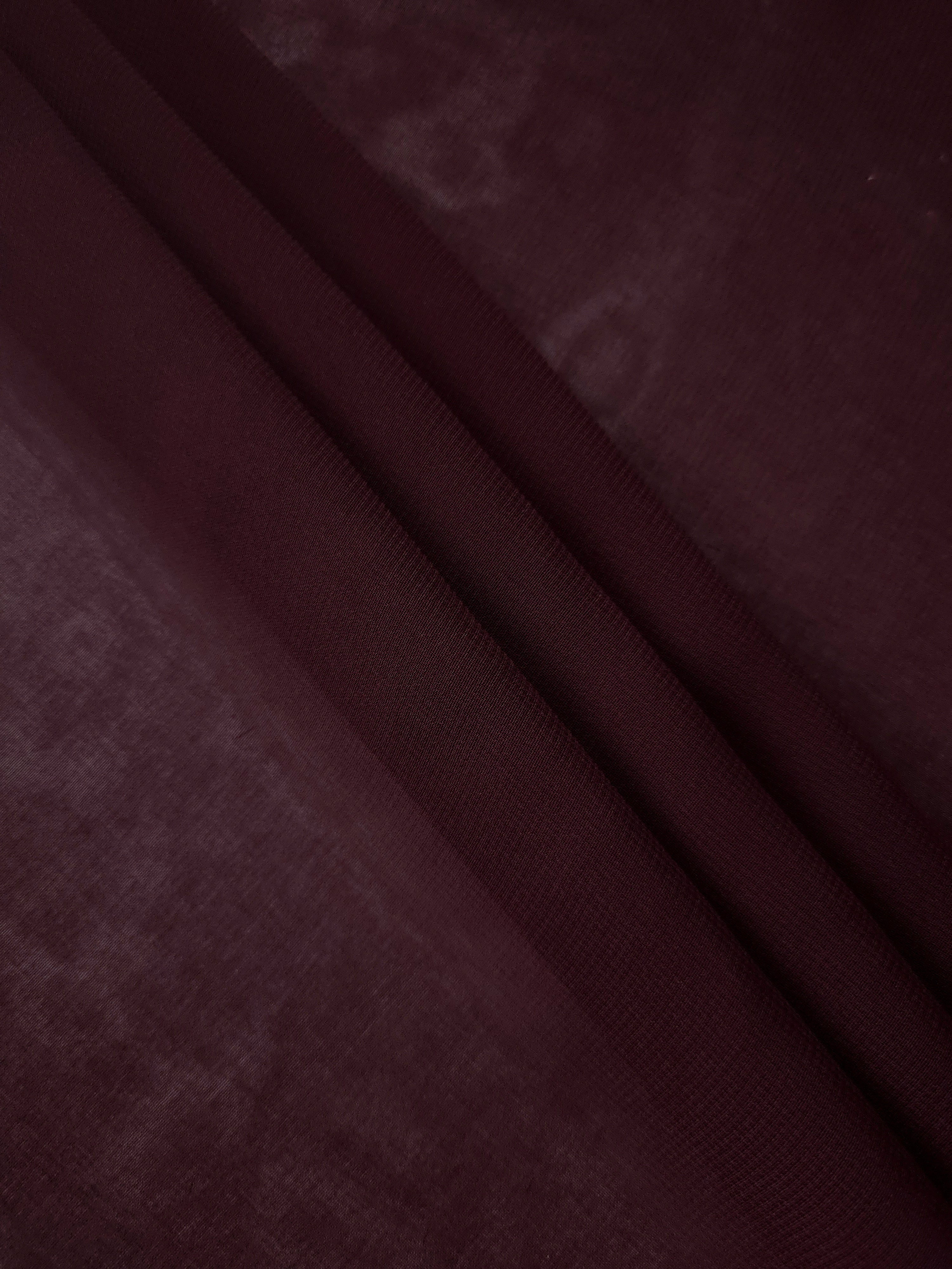 Layered Oxblood Burgundy chiffon stretch fabric displays soft depth and flowing structure for tiered skirts, cape overlays and layered formal silhouettes.
