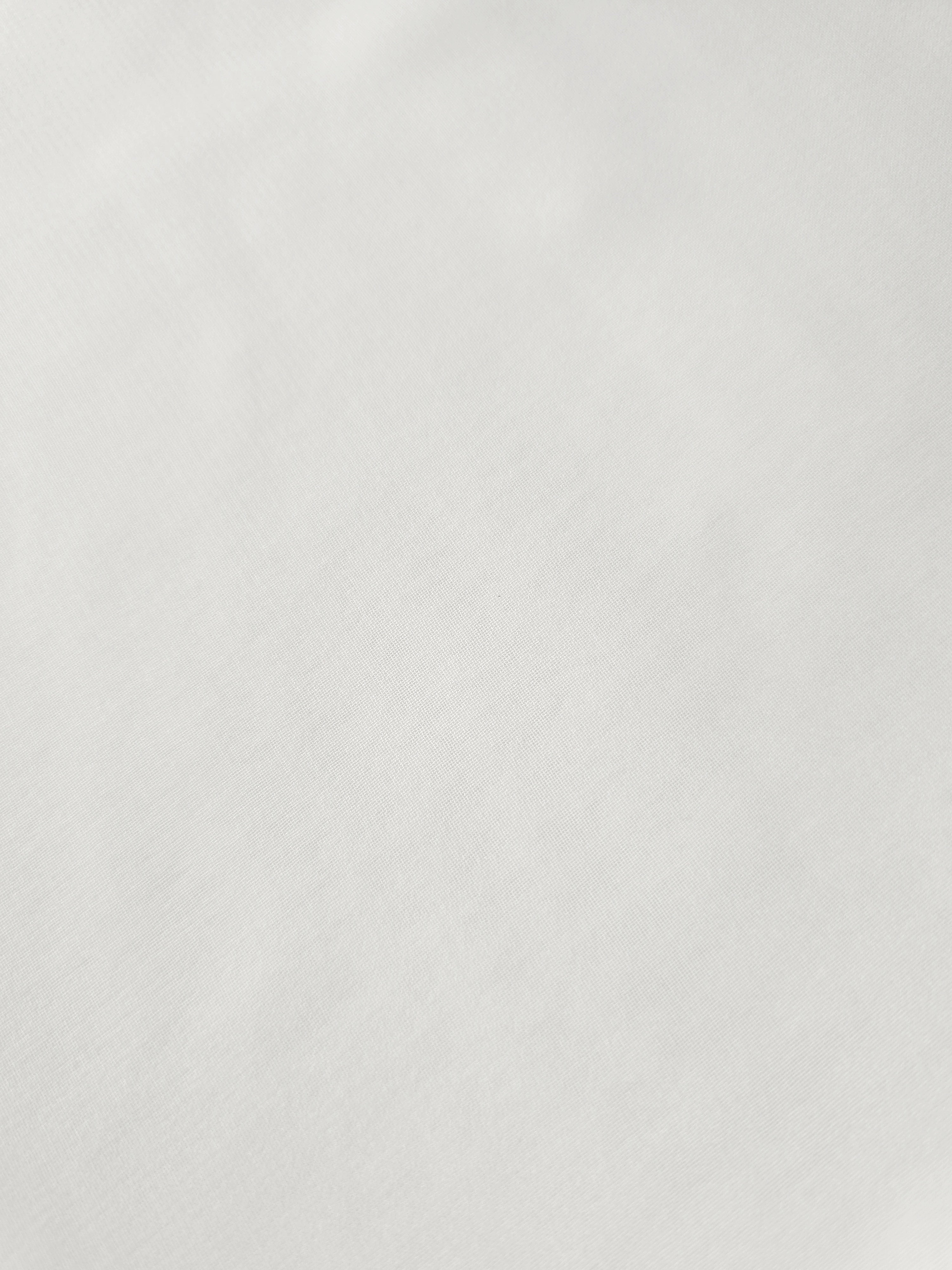 Close-up of Pearl Ivory stretch chiffon revealing fine texture and translucency for sheer wedding sleeves, ruffles and delicate inserts.
