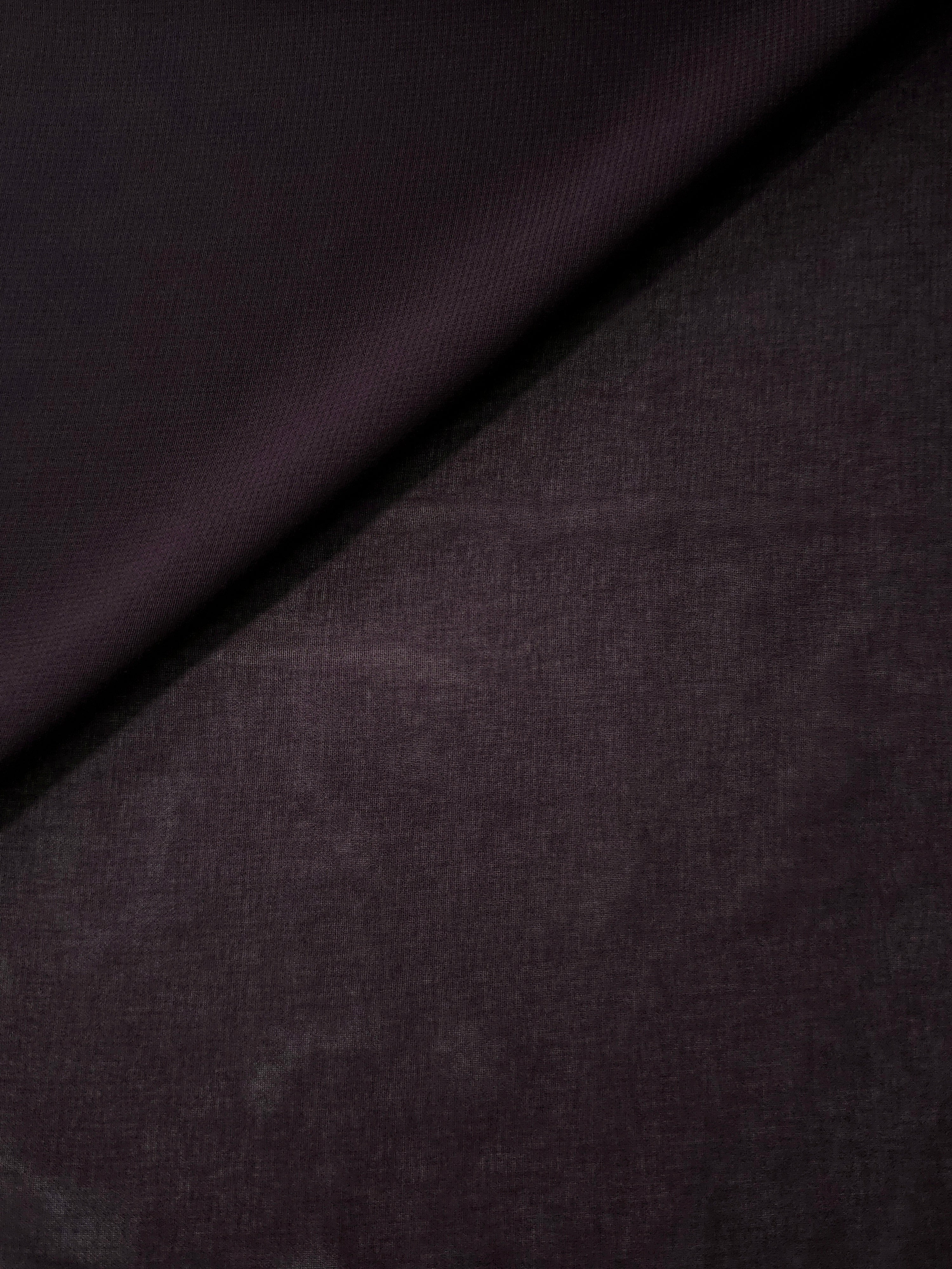 Smoky Plum stretch chiffon in a soft fold, showing fluid drape and light movement for draped tops, occasion dresses and lightweight scarves.