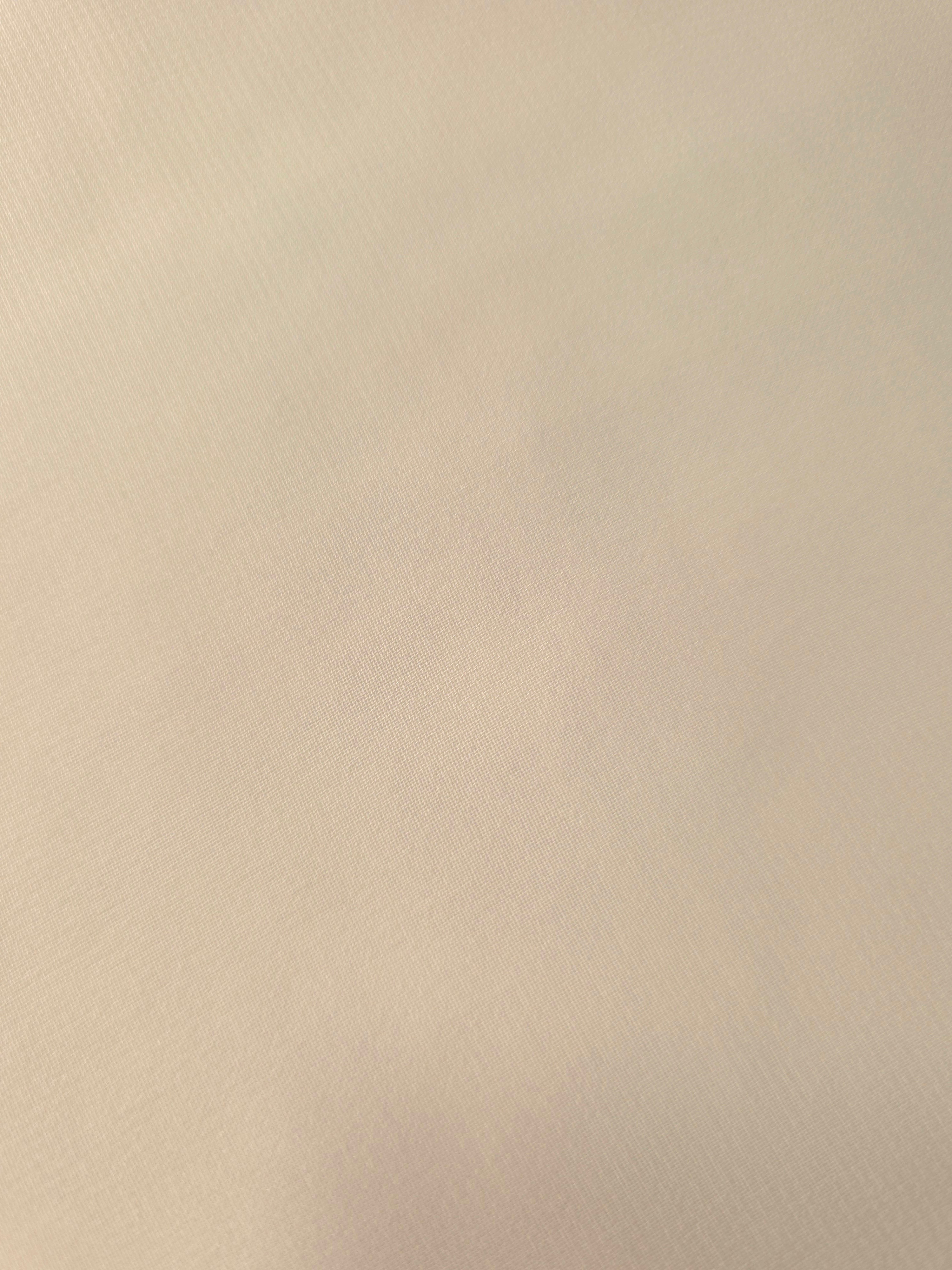 Detailed Warm Sand Beige chiffon stretch fabric close-up, highlighting its airy texture for delicate sleeves, scarf details and airy blouse accents.