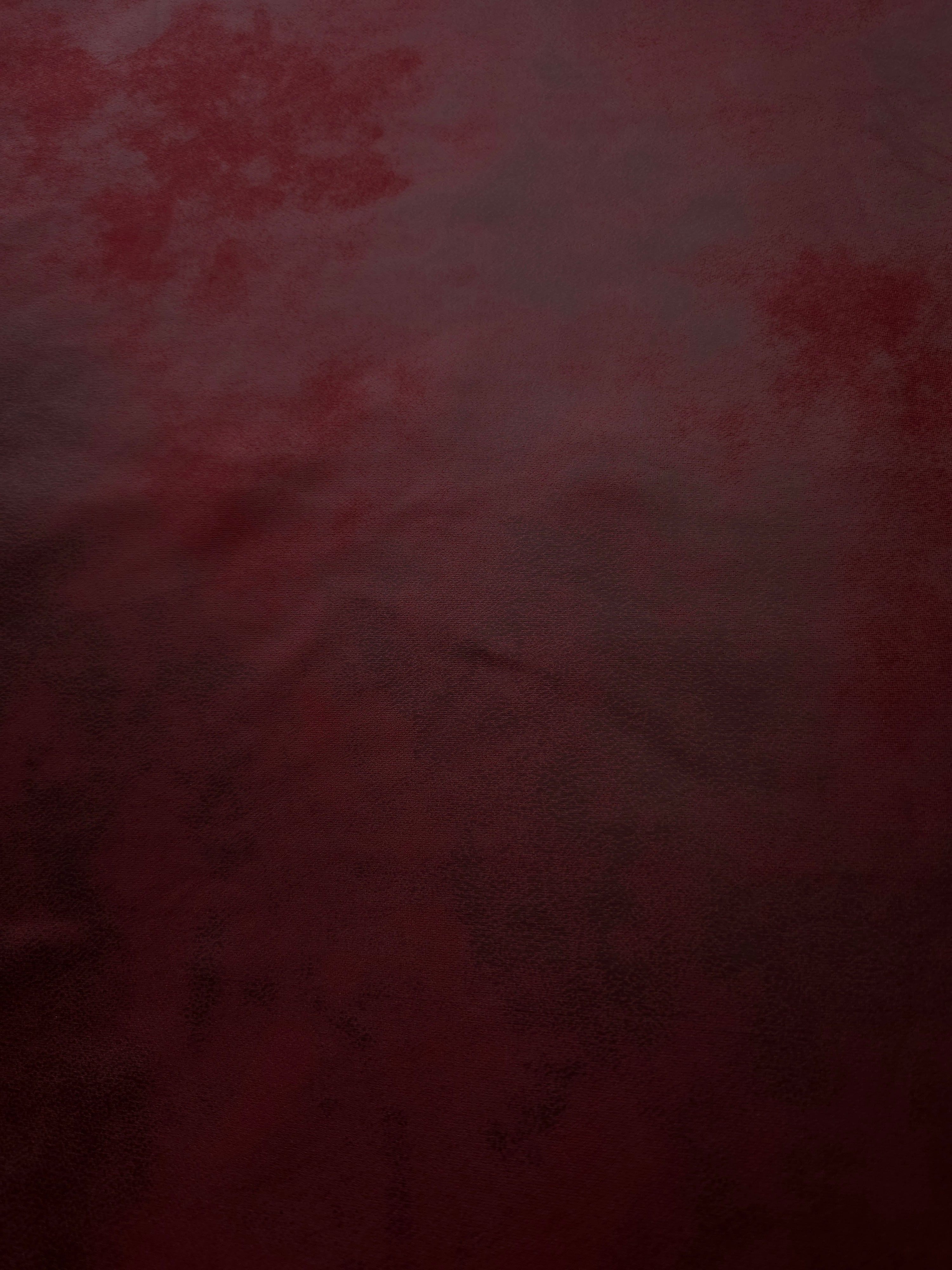 Detailed burgundy red soft faux leather stretch fabric surface with sleek texture for corsetry, fitted skirts and dress accents.