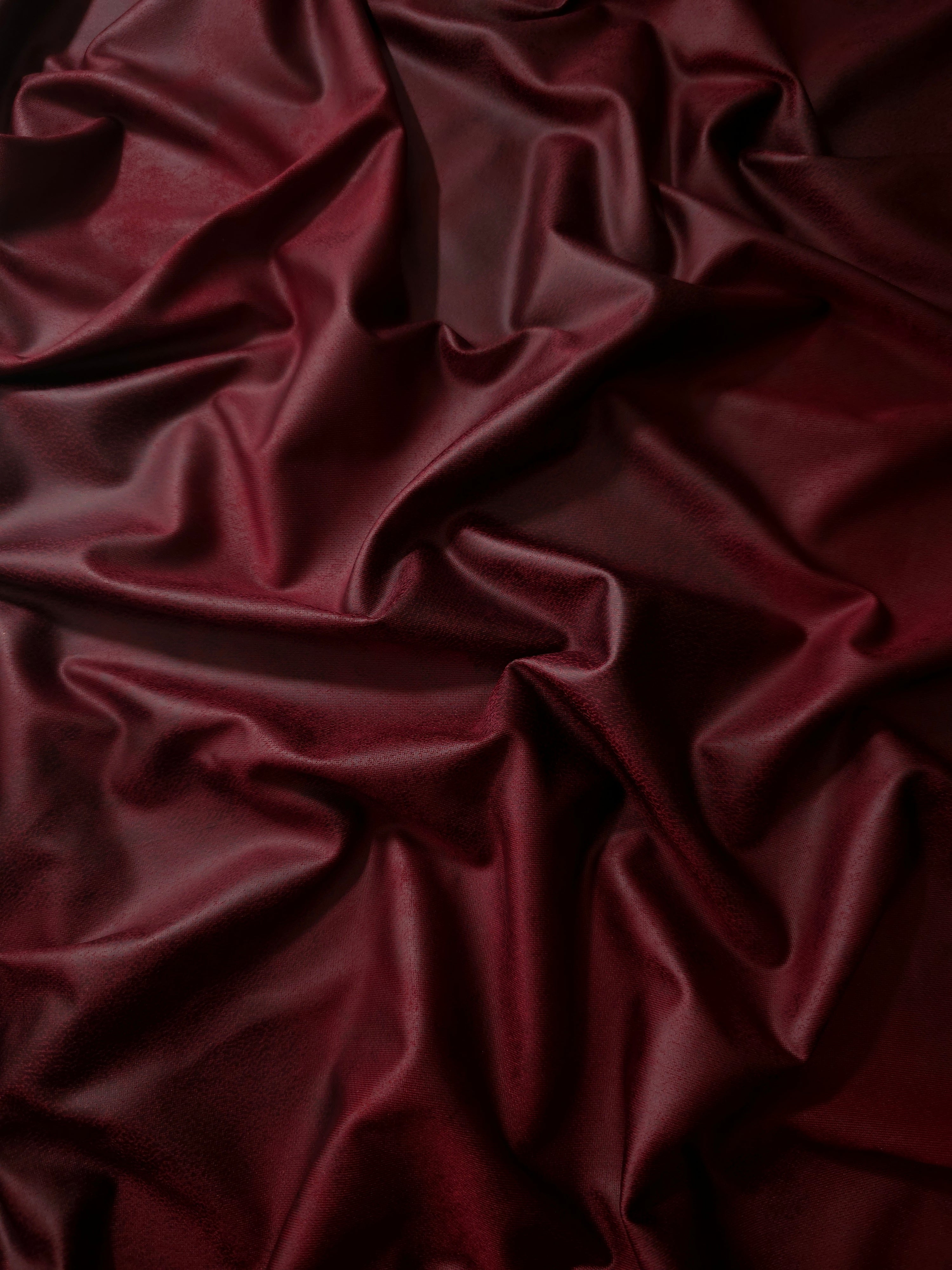 Loose burgundy red soft faux leather folds highlight flexible drape for cocktail dresses, pencil skirts and sleek separates.