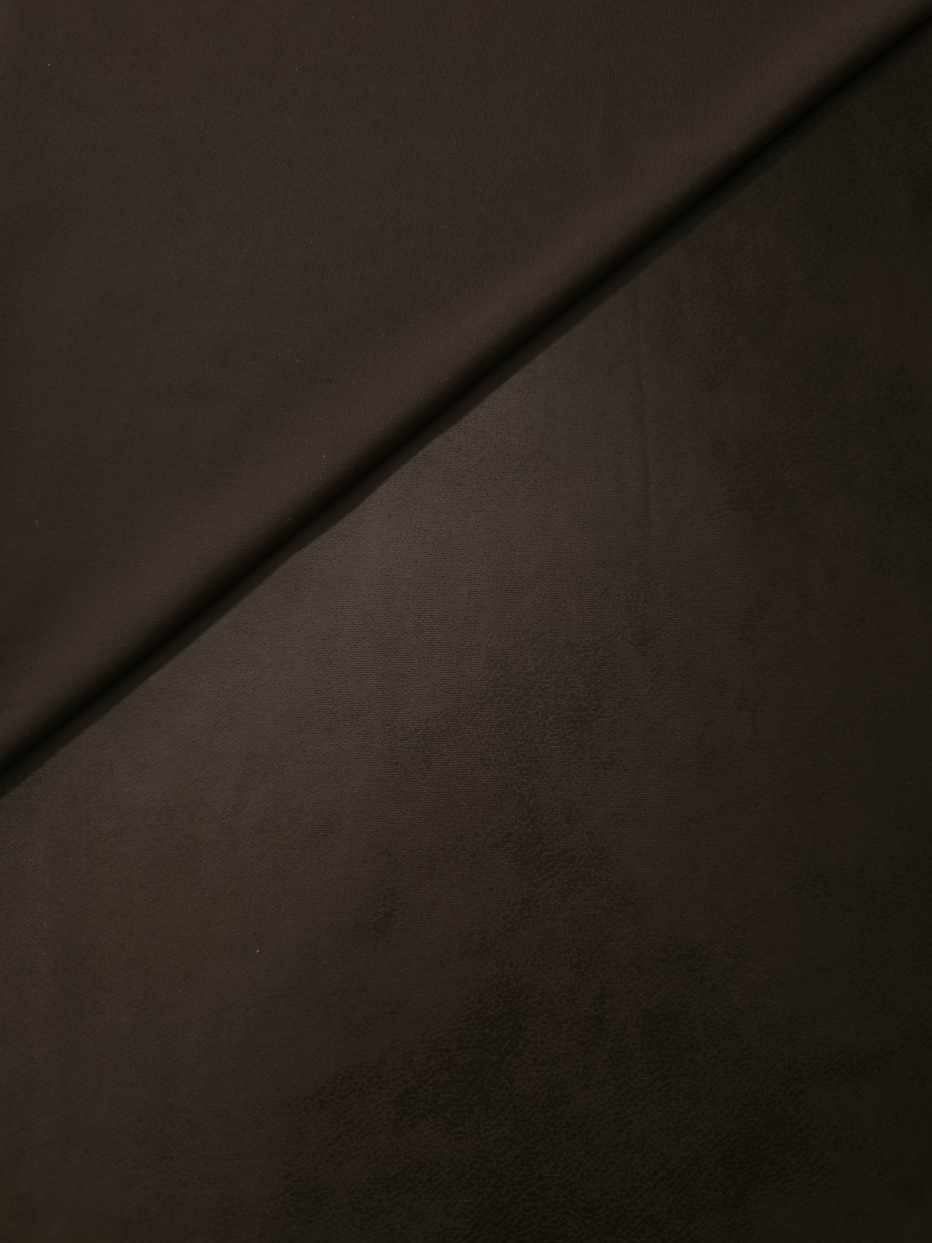 Front and reverse sides of deep espresso brown stretch faux leather, comparing finish and backing for jackets, corset tops and garment panels.