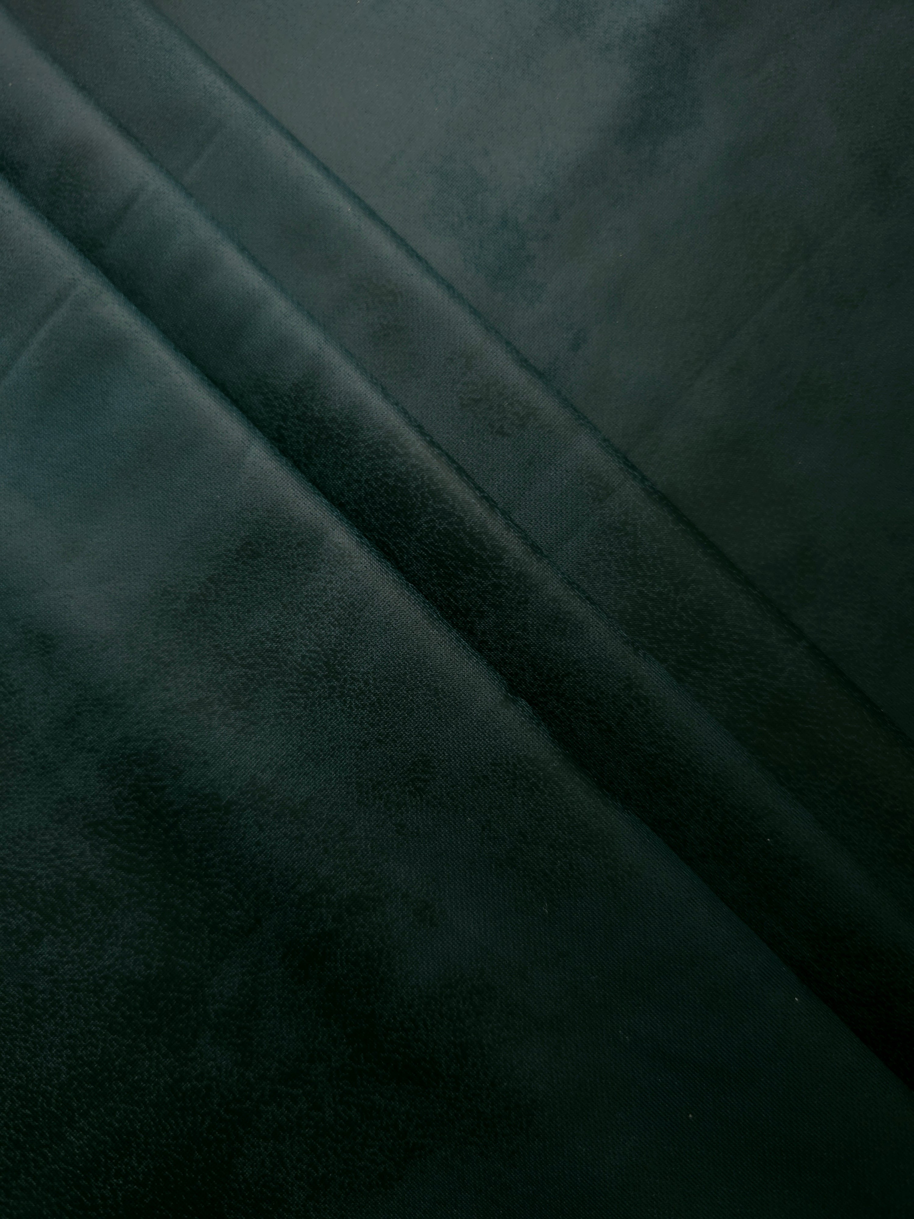 Layered folds in deep forest green stretch faux leather reveal flexible body for slim pants, pencil skirts and fashion separates.