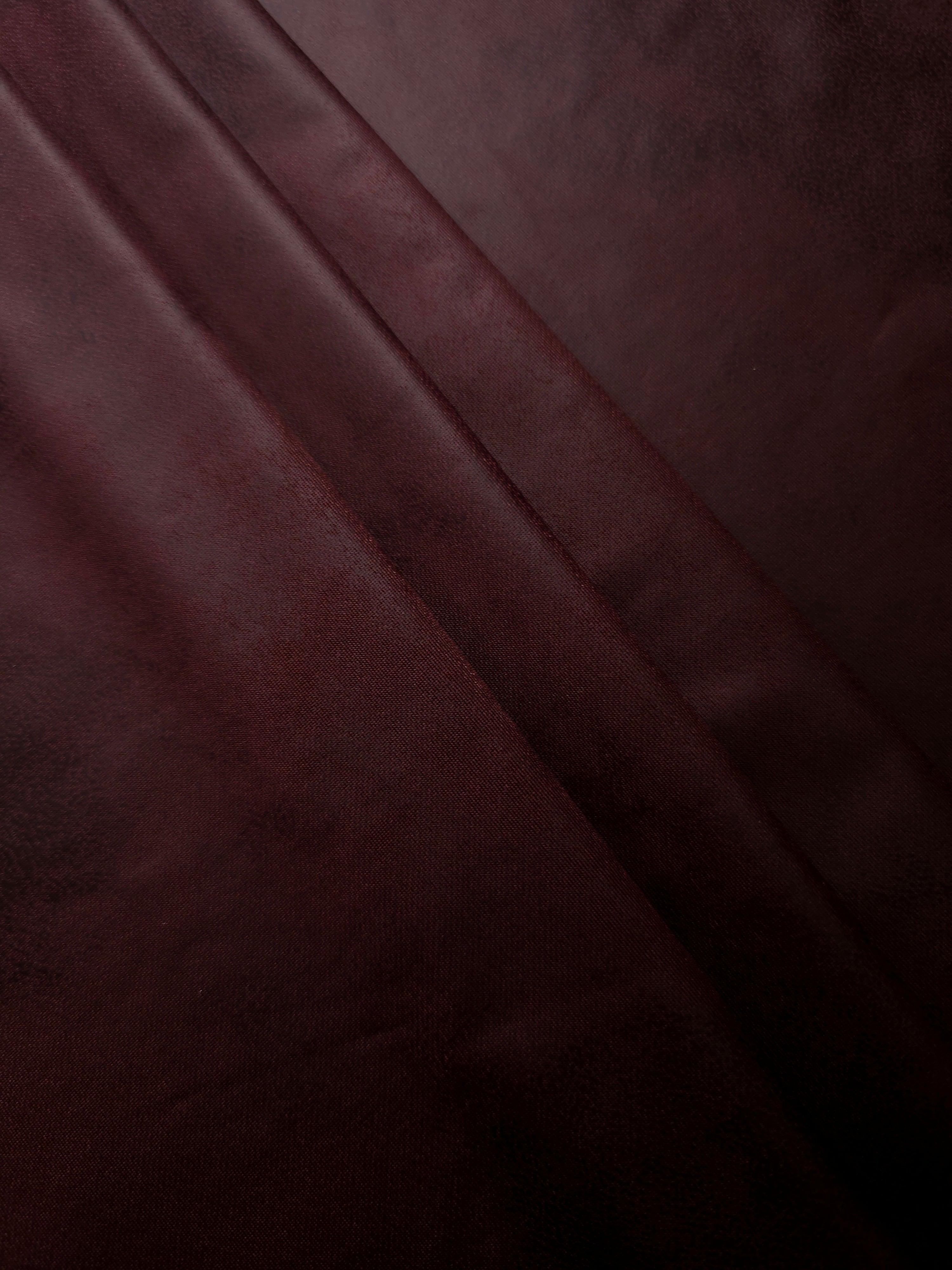 Layered deep plum faux leather folds showing soft structure and stretch for pencil skirts, sleek trousers and occasion separates.