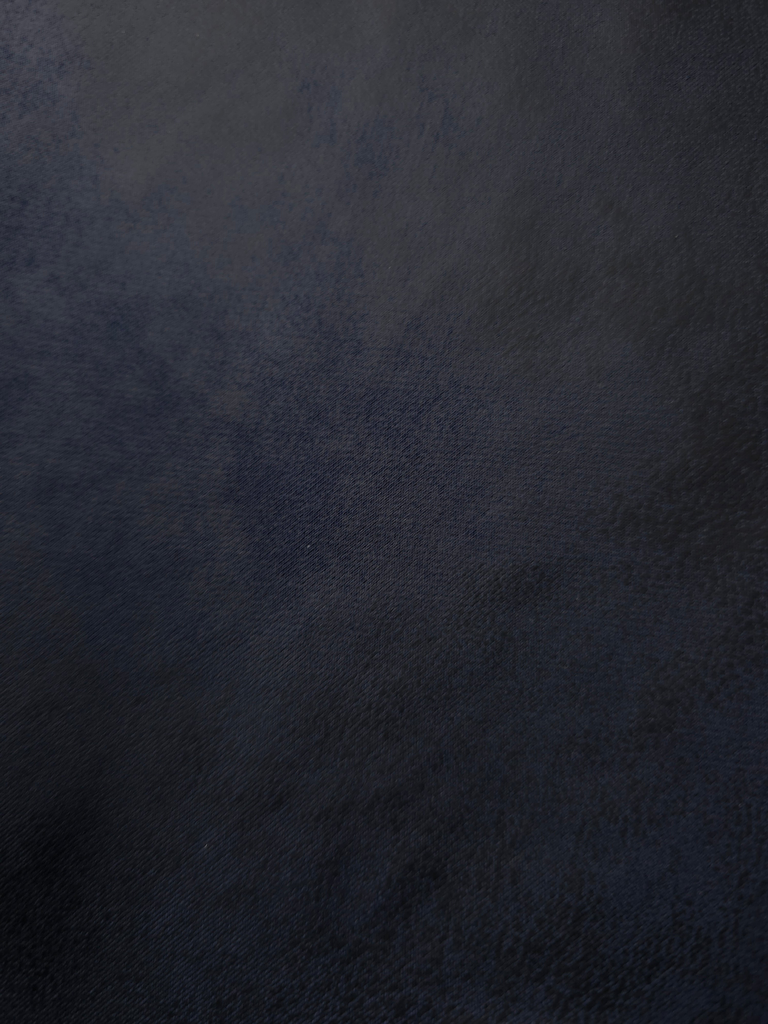 Midnight navy stretch faux leather laid flat, showing a smooth leather-look finish for tailored trousers, skirts and modern apparel.