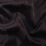 Big Flower tonal viscose jacquard fabric in a wave fold, showing silky sheen