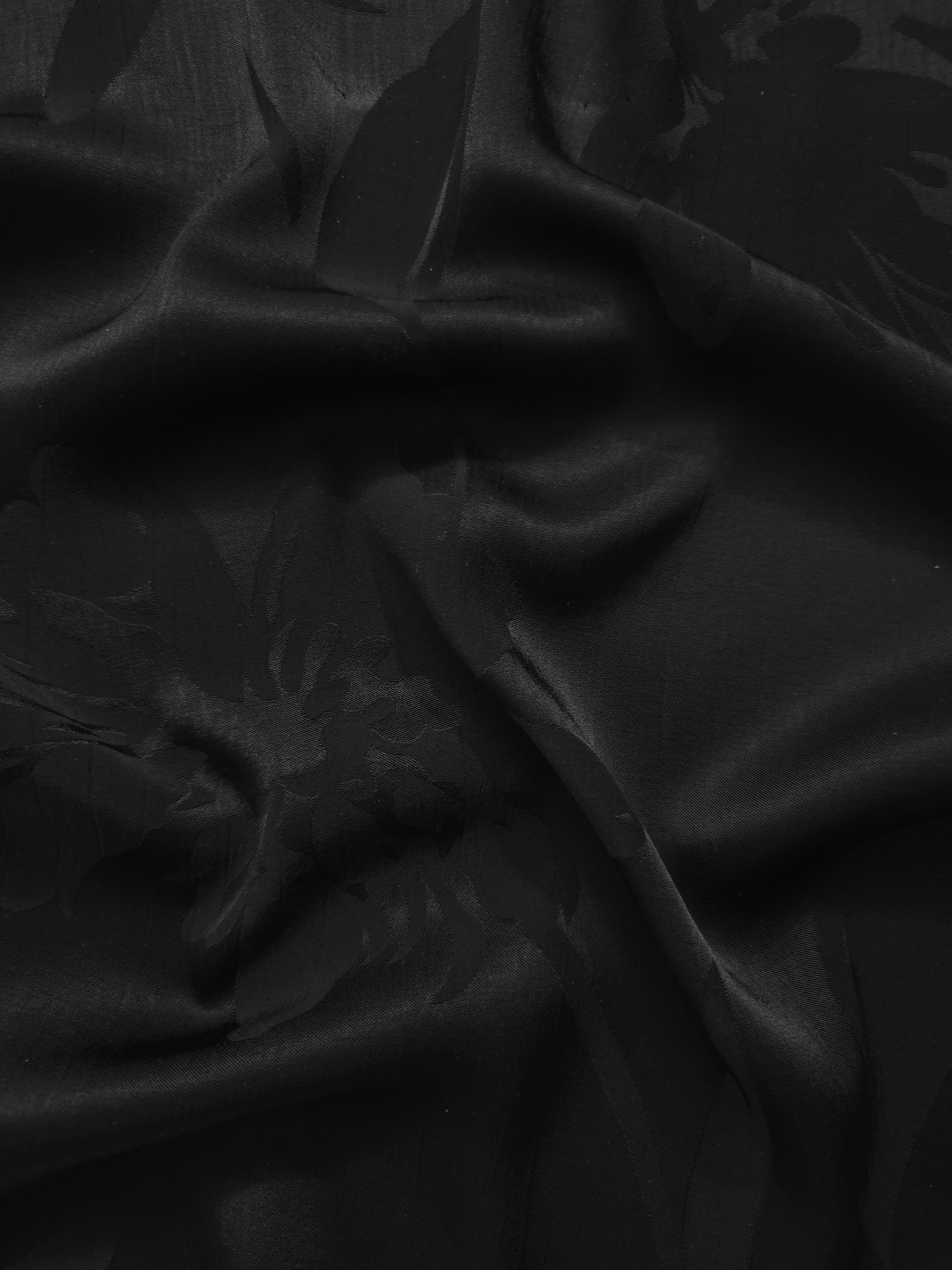Big Flower tonal viscose jacquard fabric in a wave fold, showing silky sheen