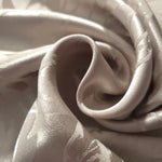 Close-up of draped Branch tonal jacquard fabric showing silky texture and fold detail