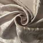 Branch self-jacquard tonal viscose fabric draped, showing silky fluid movement
