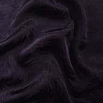 Brush tonal viscose jacquard fabric in a wave fold, showing silky sheen