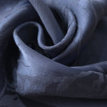 Close-up of draped Daisy tonal jacquard fabric showing silky texture and fold detail