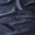 Daisy tonal viscose jacquard fabric in a wave fold, showing silky sheen