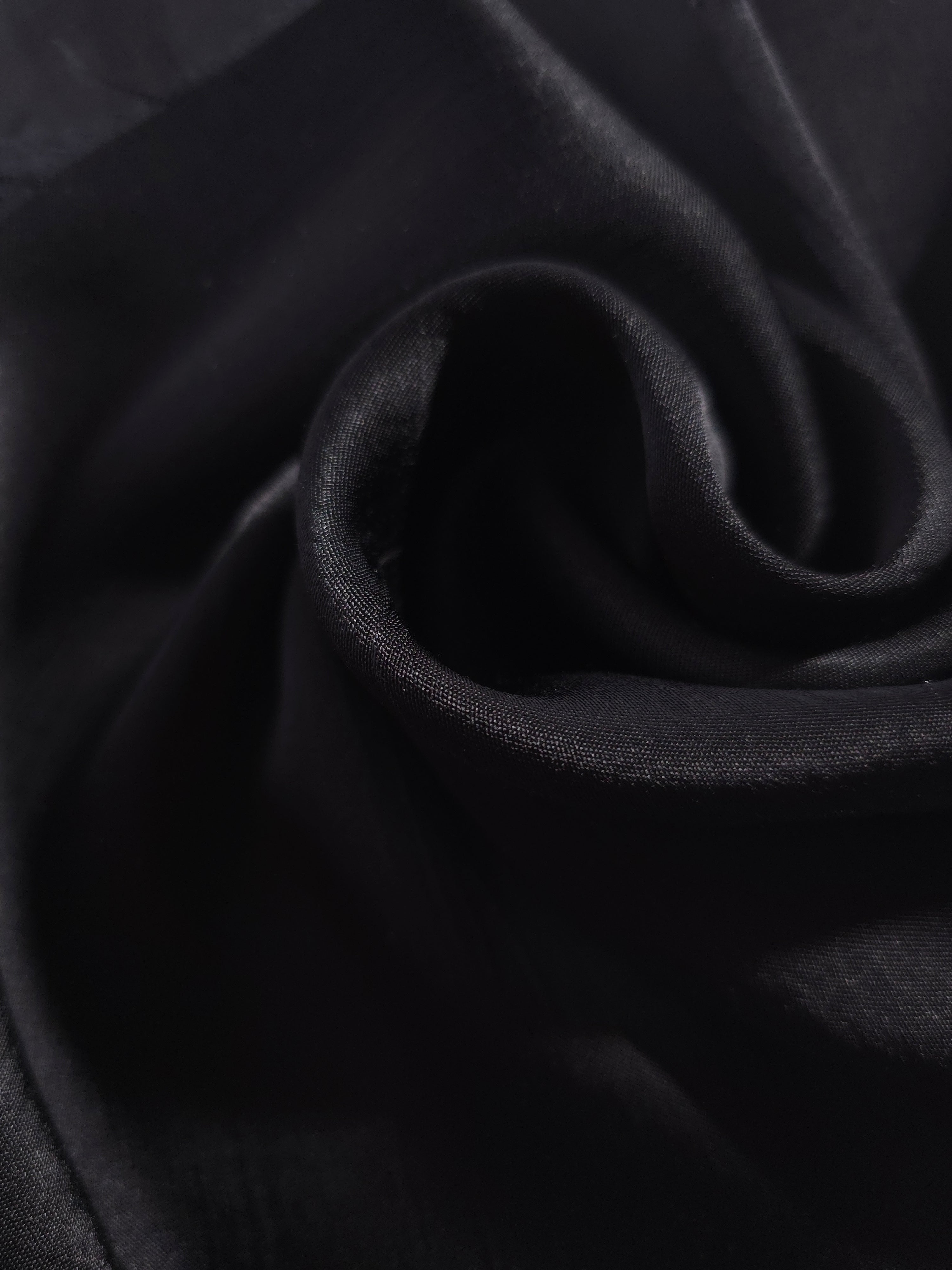 Close-up of draped Flat tonal jacquard fabric showing silky texture and fold detail