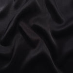 Flat tonal viscose jacquard fabric in a wave fold, showing silky sheen