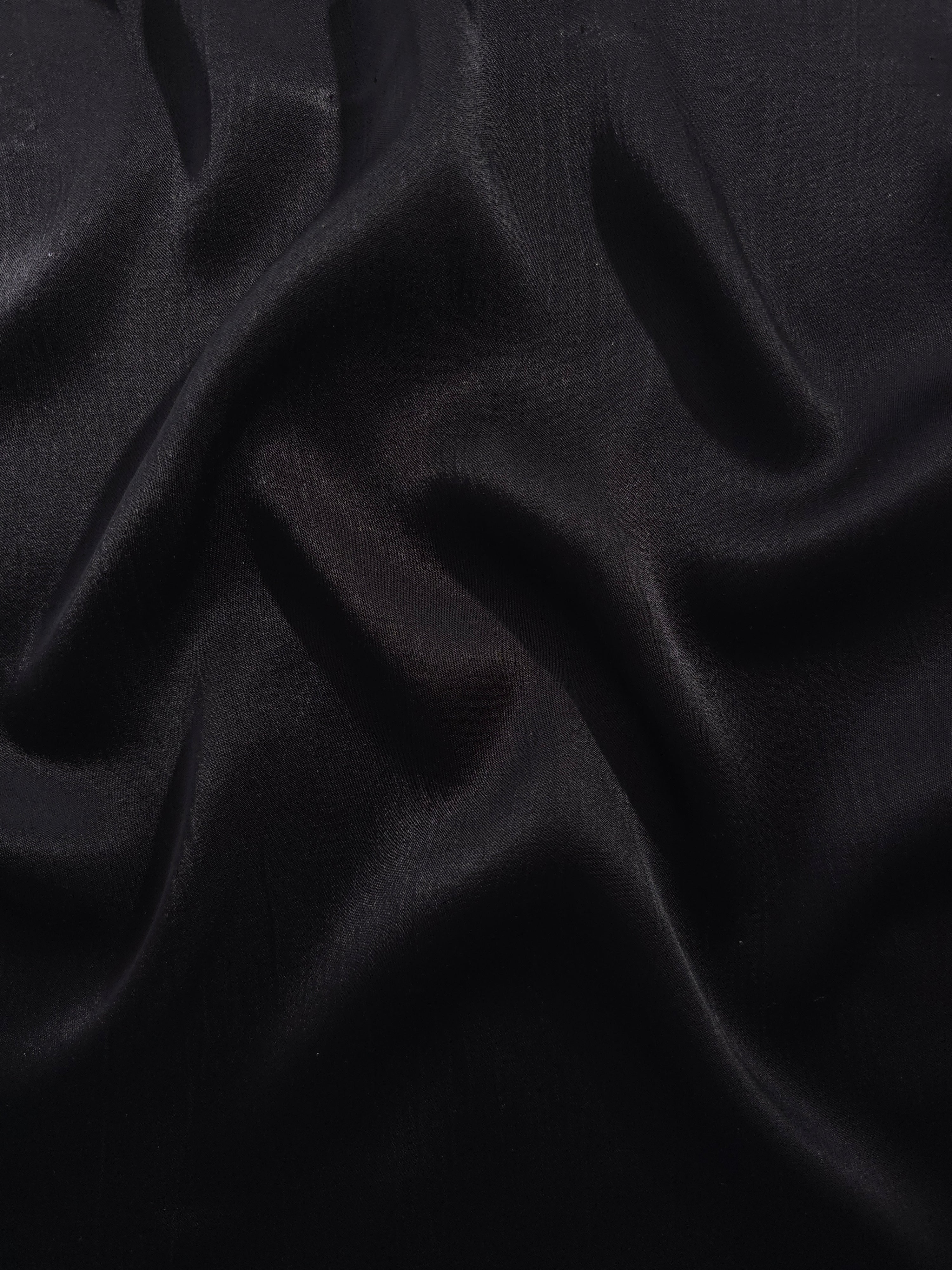 Flat tonal viscose jacquard fabric in a wave fold, showing silky sheen