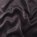 Flat tonal viscose jacquard fabric in a wave fold, showing silky sheen