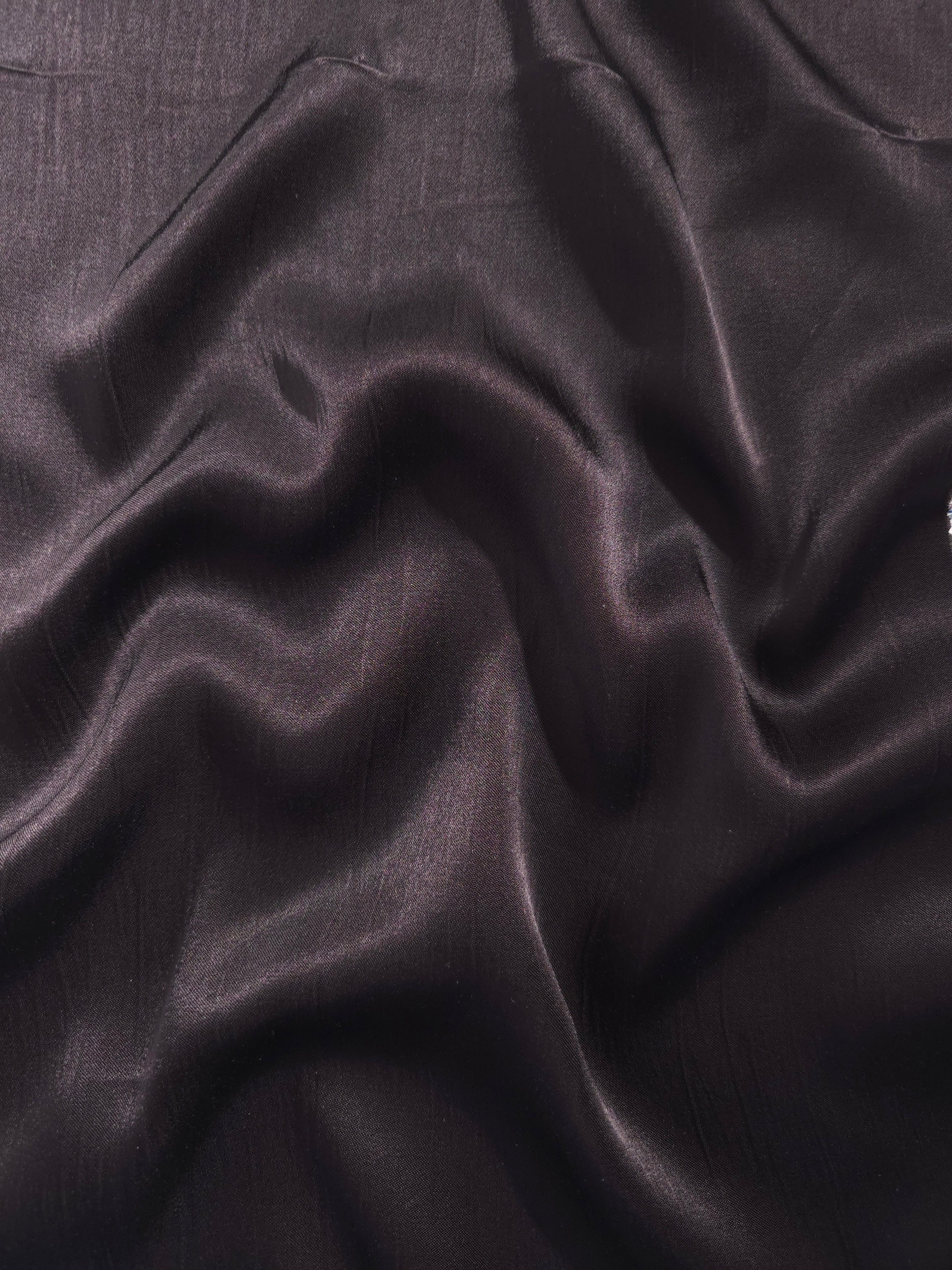 Flat tonal viscose jacquard fabric in a wave fold, showing silky sheen