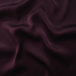 Flat tonal viscose jacquard fabric in a wave fold, showing silky sheen