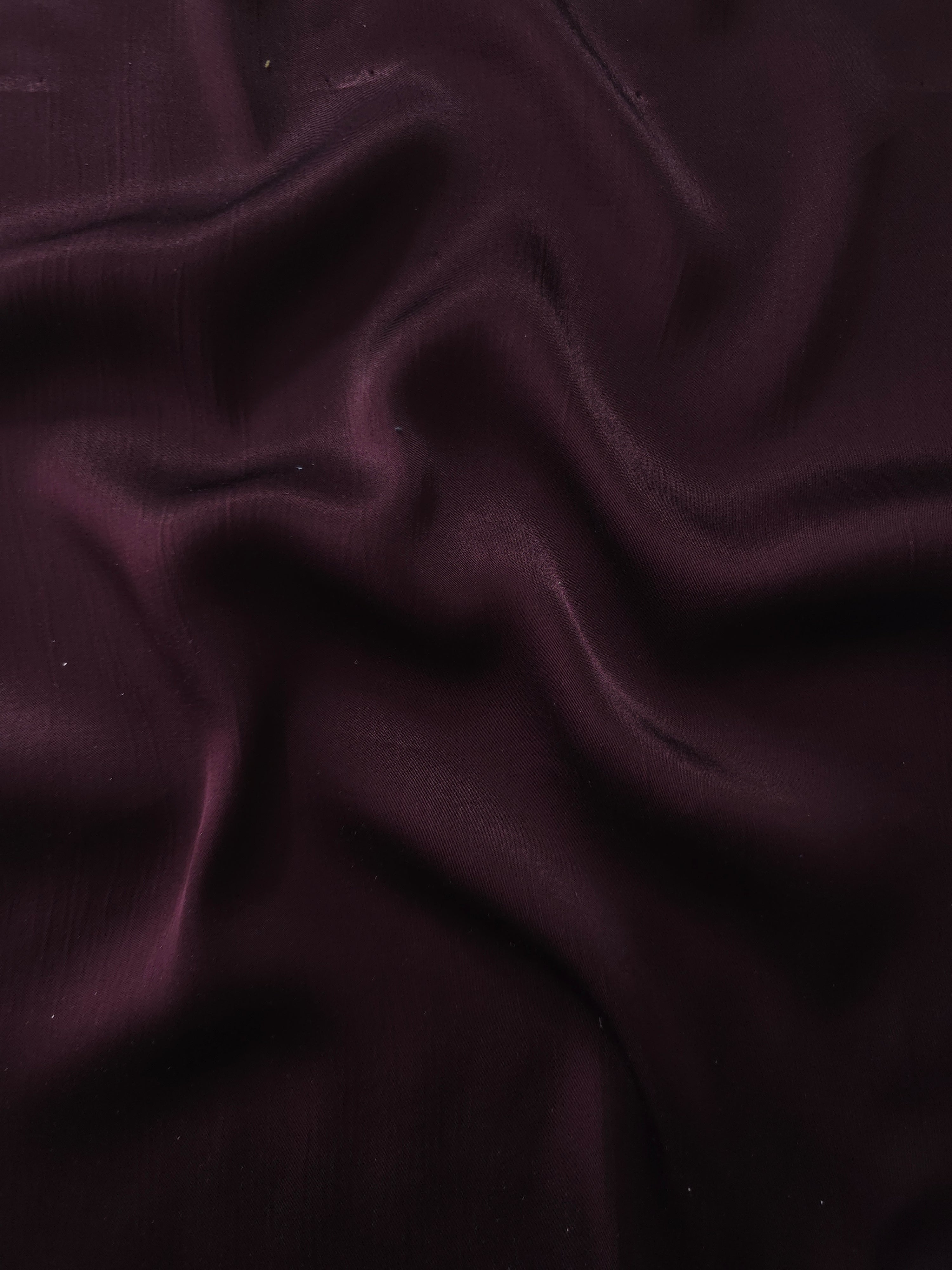 Flat tonal viscose jacquard fabric in a wave fold, showing silky sheen