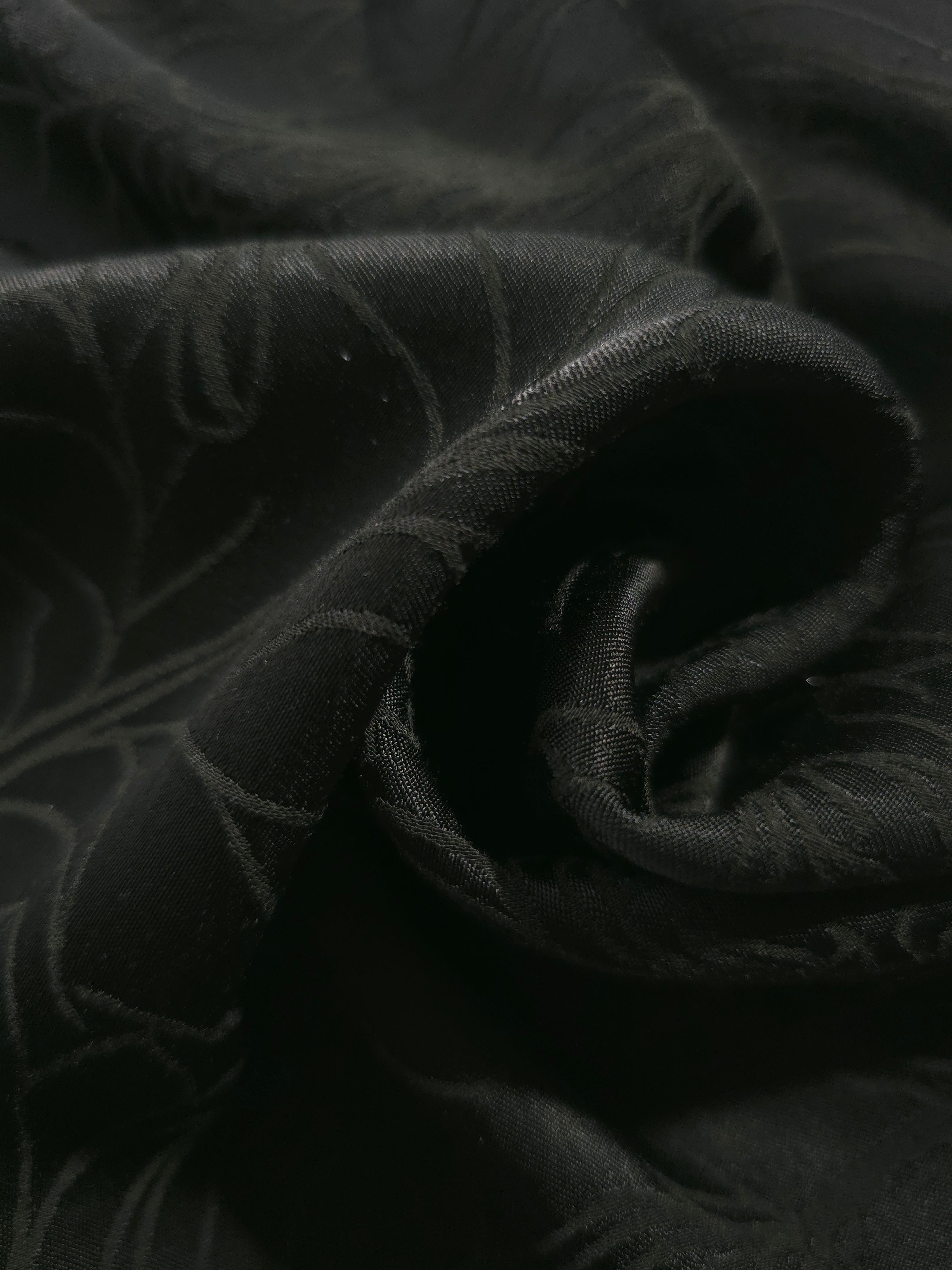 Close-up of draped Floral tonal jacquard fabric showing silky texture and fold detail