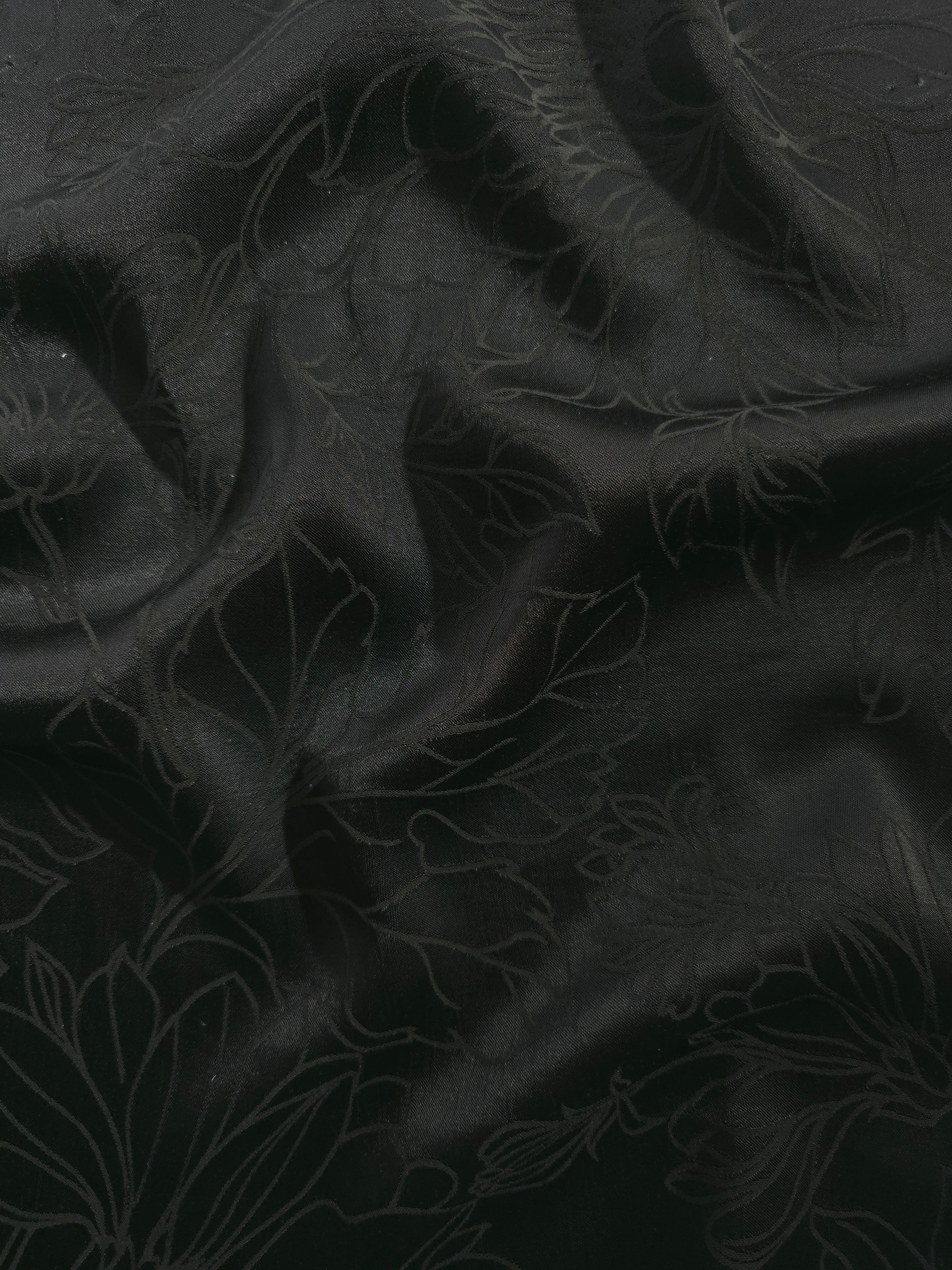 Floral tonal viscose jacquard fabric in a wave fold, showing silky sheen
