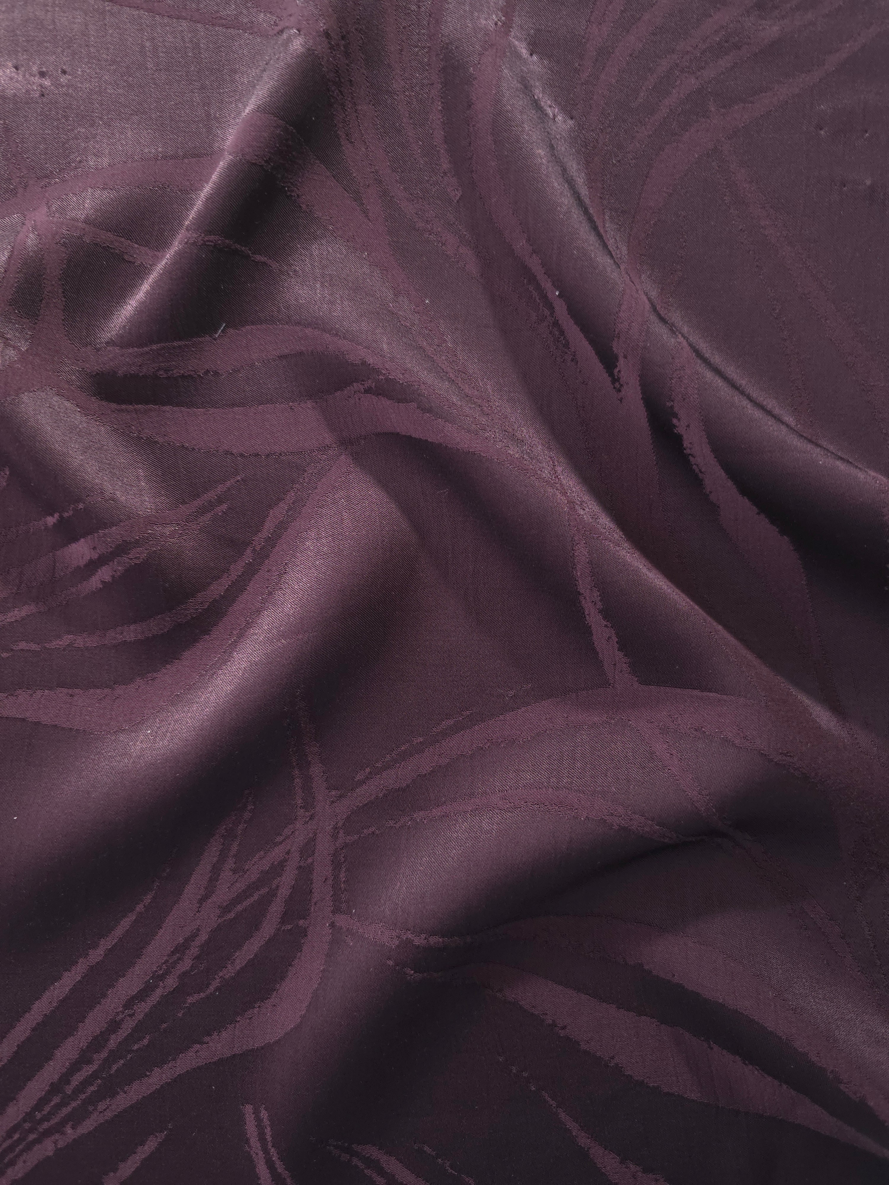 Seaweed tonal viscose jacquard fabric in a wave fold, showing silky sheen