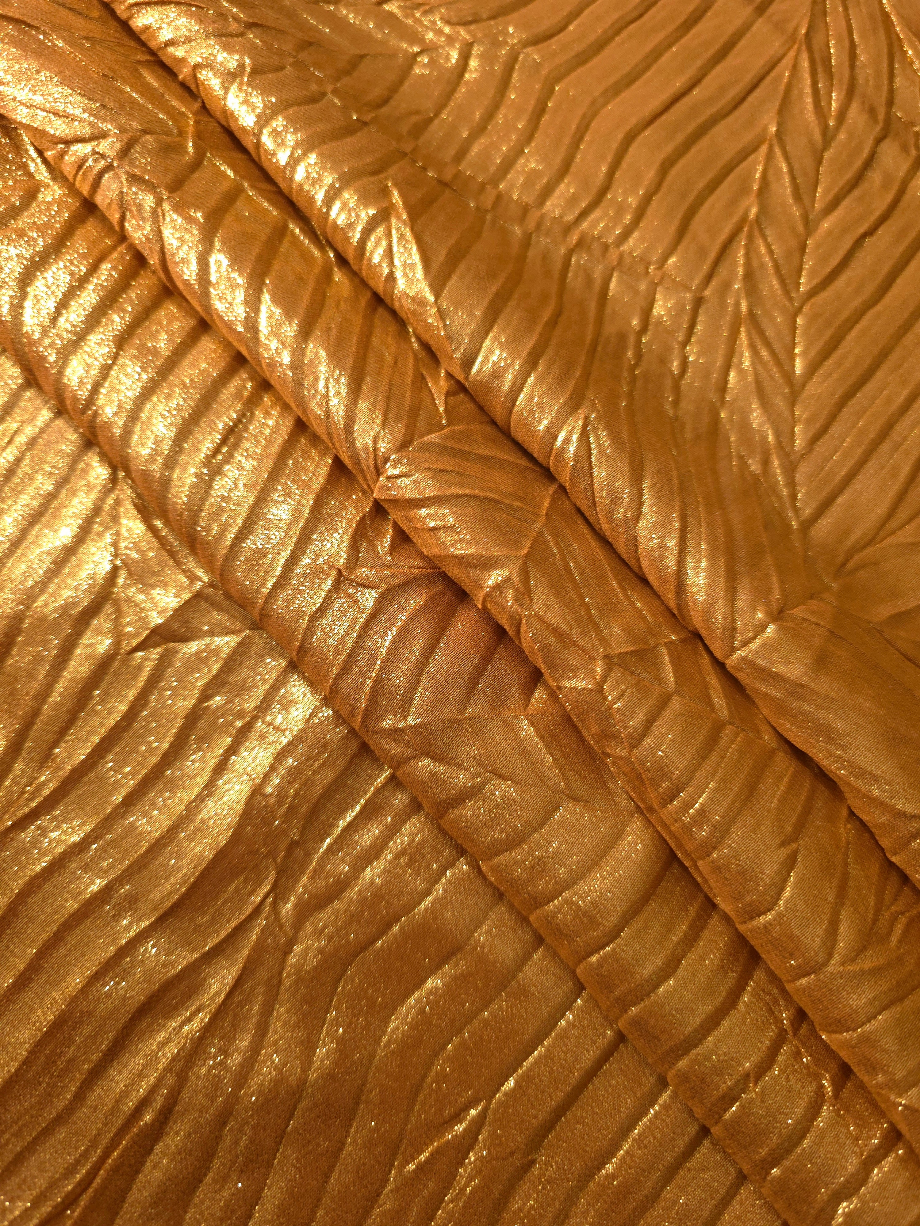 Burnished Copper leaf-pattern plissé fabric in close detail, revealing the fine shimmer and dimensional pleat structure suited to bodice accents and fashion-forward blouses.
