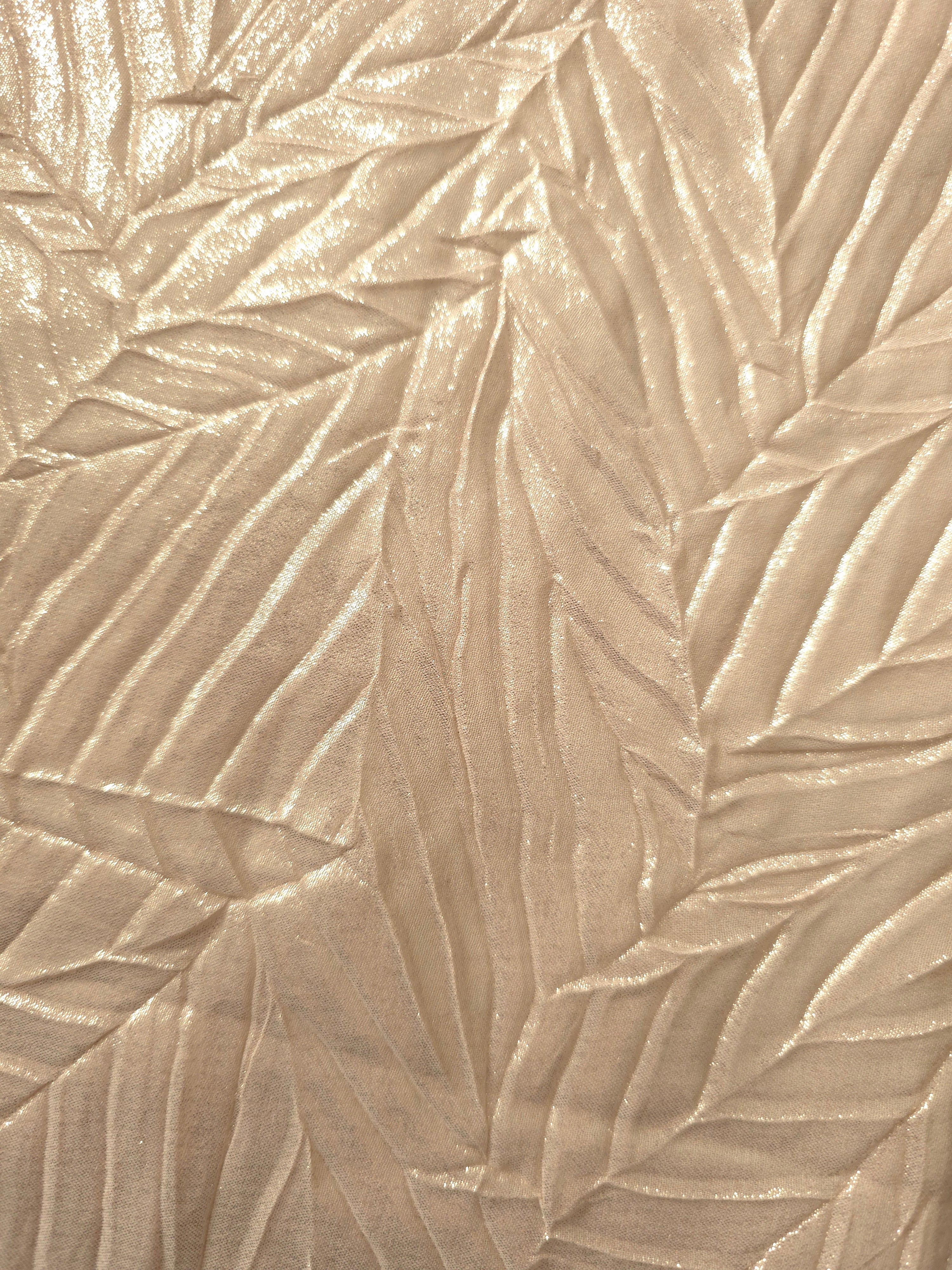 Soft drape of Champagne Cream textured shimmer plissé reveals dimensional folds and shifting reflection for jumpsuits and fluid occasionwear.