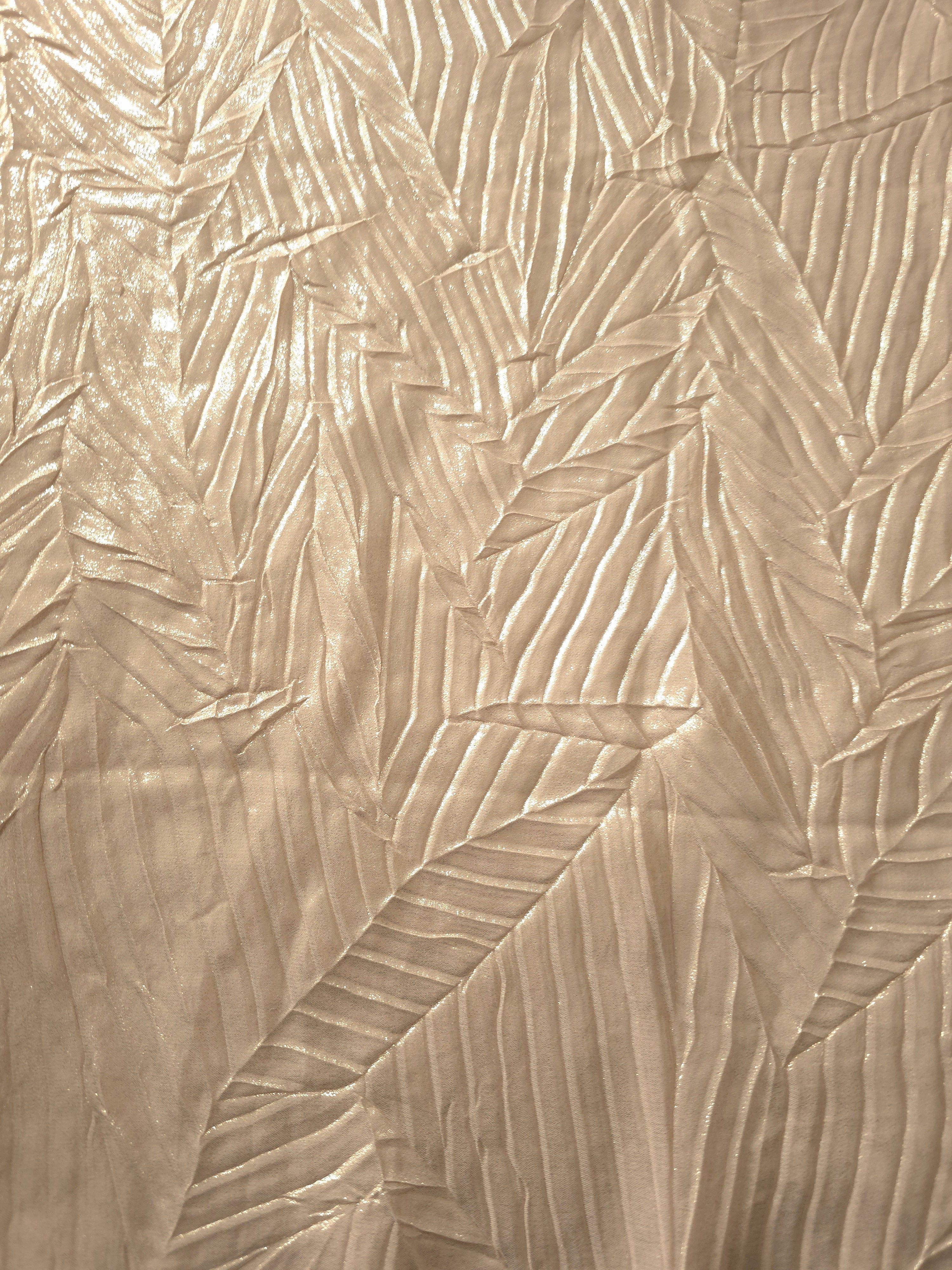 Surface detail of Champagne Cream leaf-pattern plissé shimmer fabric showcases sculpted leaf-like pleats for evening clutches, garment accents and special-occasion pieces.