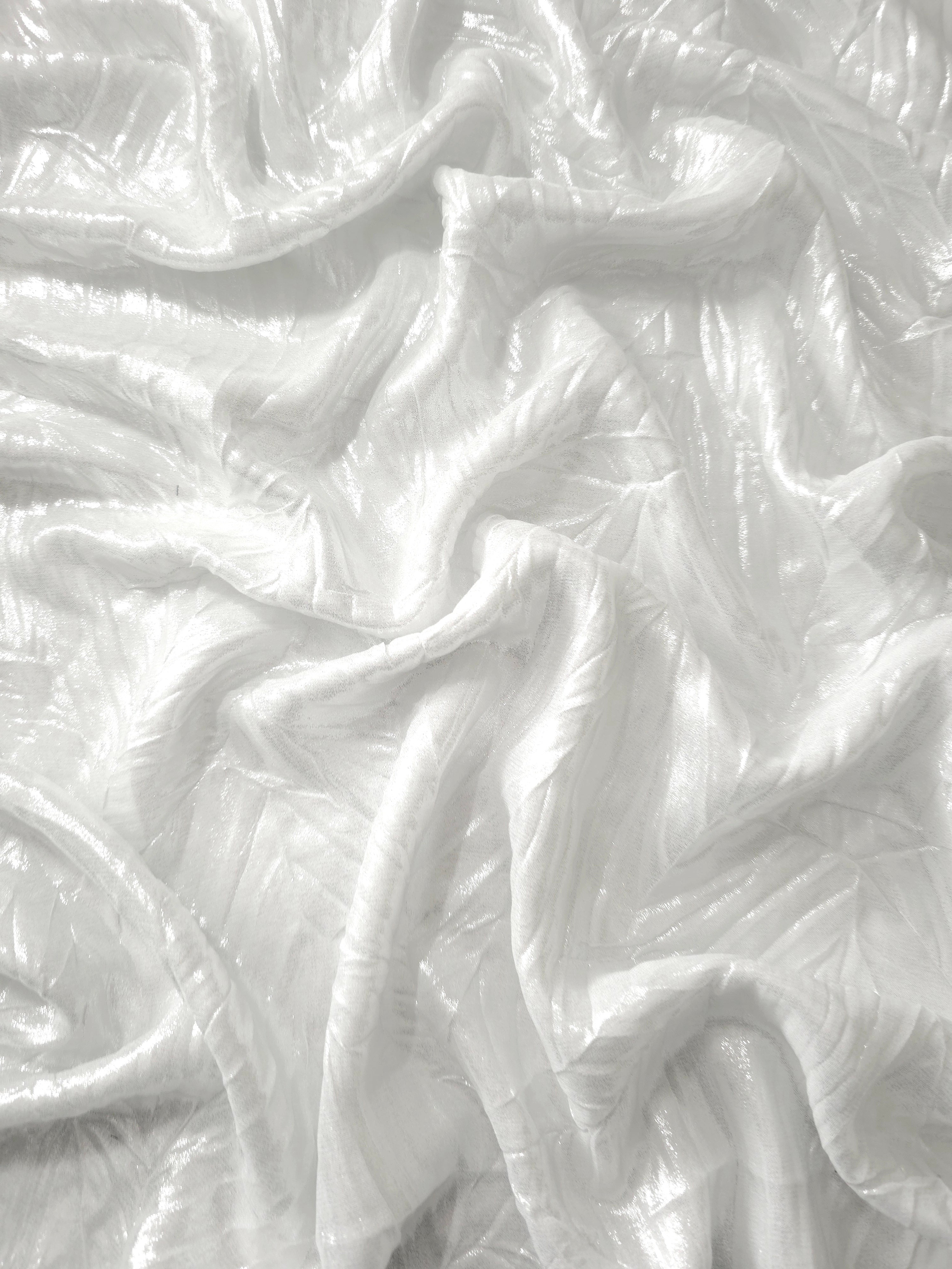 Flowing drape of Frost White leaf-pattern plissé shimmer fabric, showing sculpted leaf-like pleats and light-catching movement for evening gowns and flowing maxi skirts.