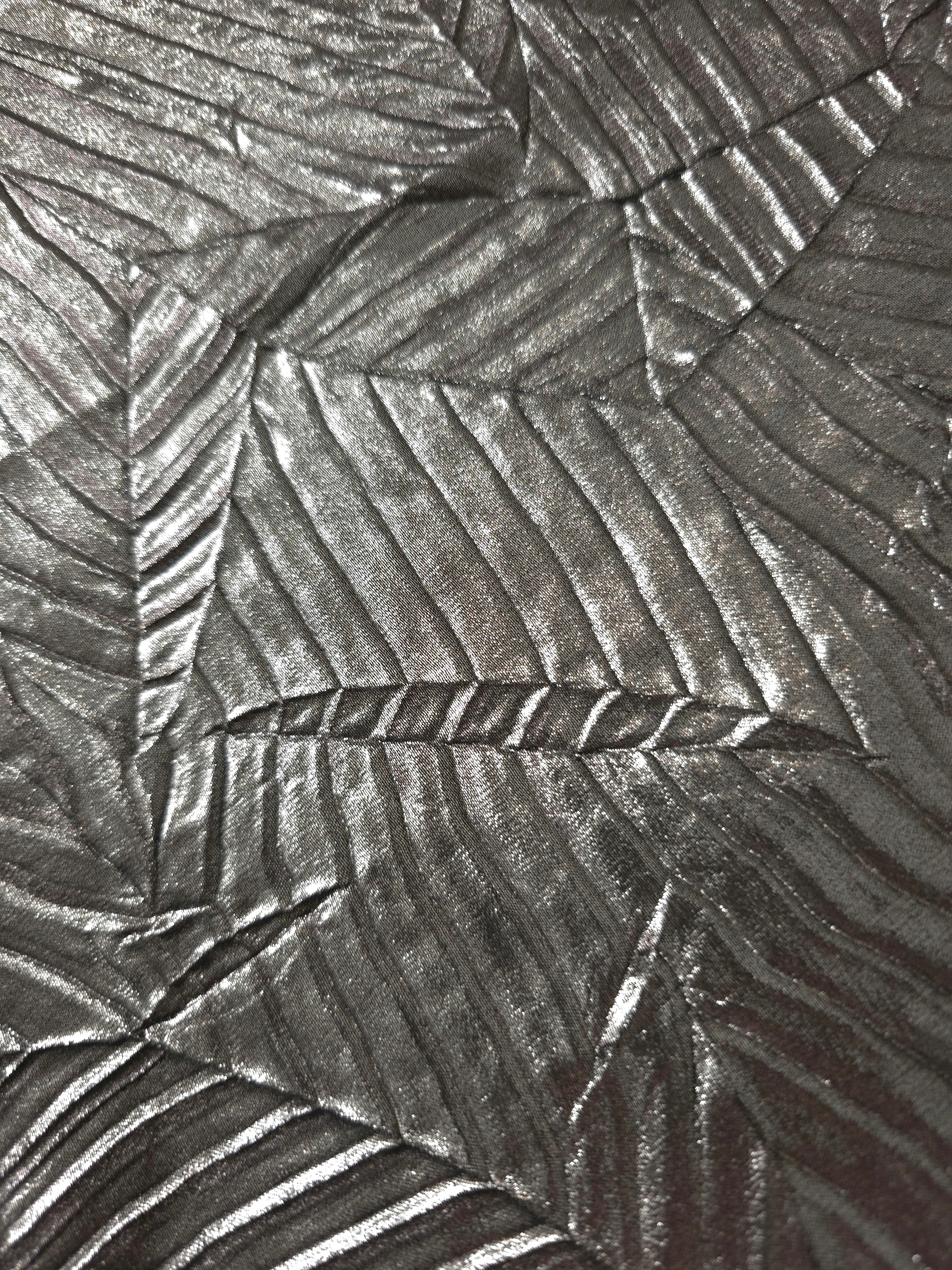 Soft drape of Graphite Gray textured shimmer plissé reveals dimensional folds and shifting reflection for jumpsuits and fluid occasionwear.