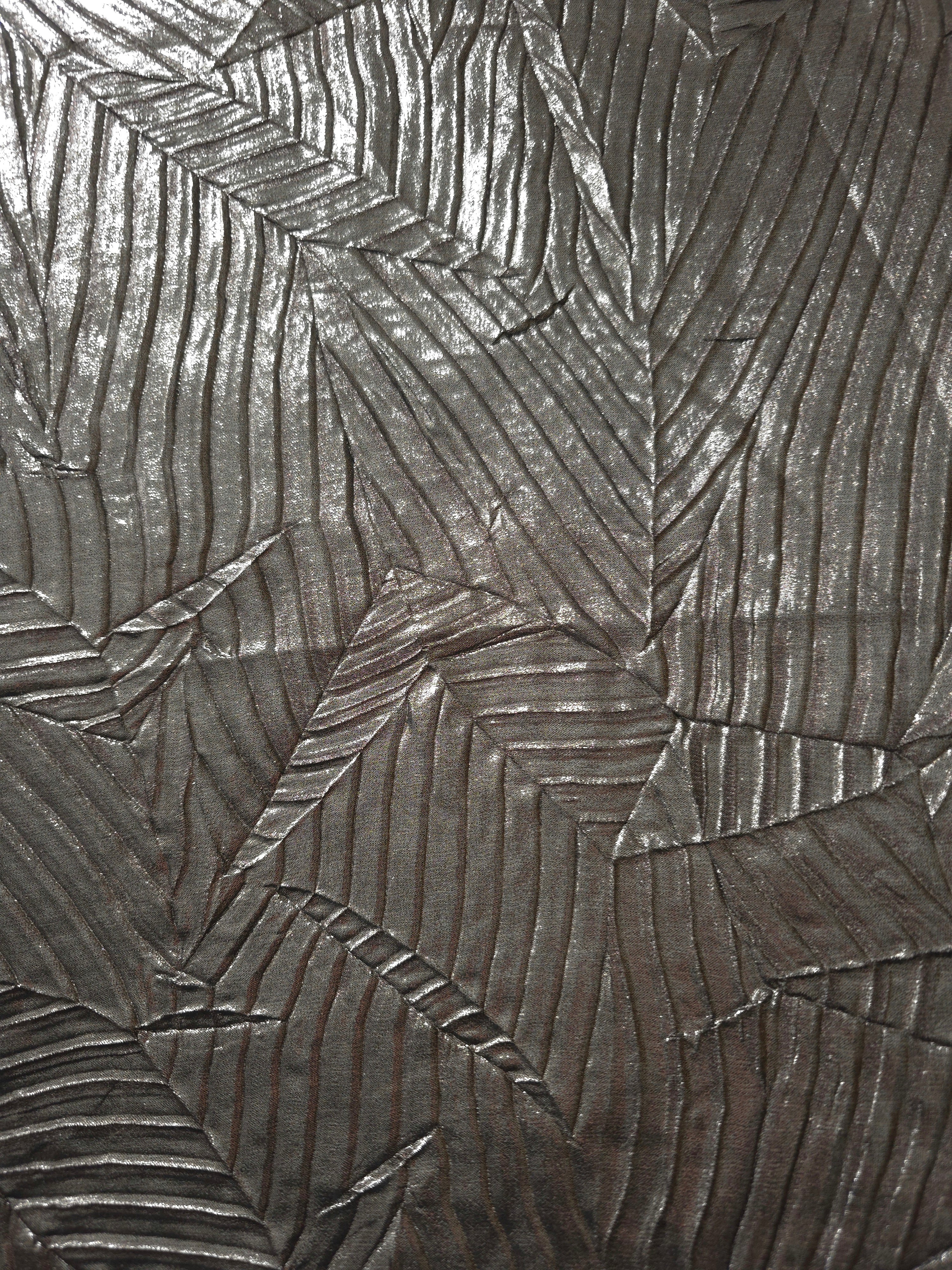 Surface detail of Graphite Gray leaf-pattern plissé shimmer fabric showcases sculpted leaf-like pleats for evening clutches, garment accents and special-occasion pieces.