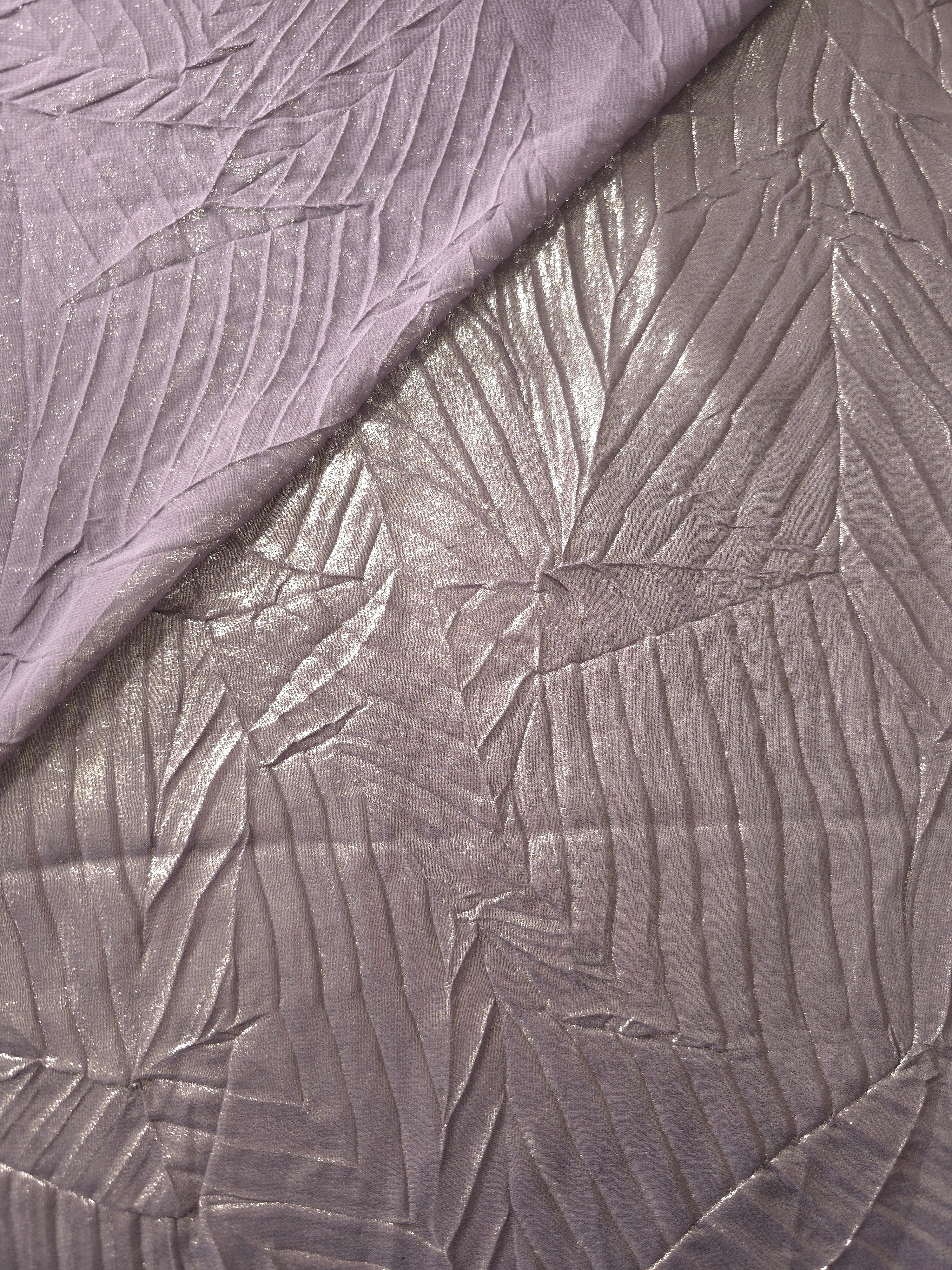 Fold detail of Lavender Taupe leaf-pattern plissé fabric demonstrates how the textured surface builds depth for stagewear and layered fashion details.