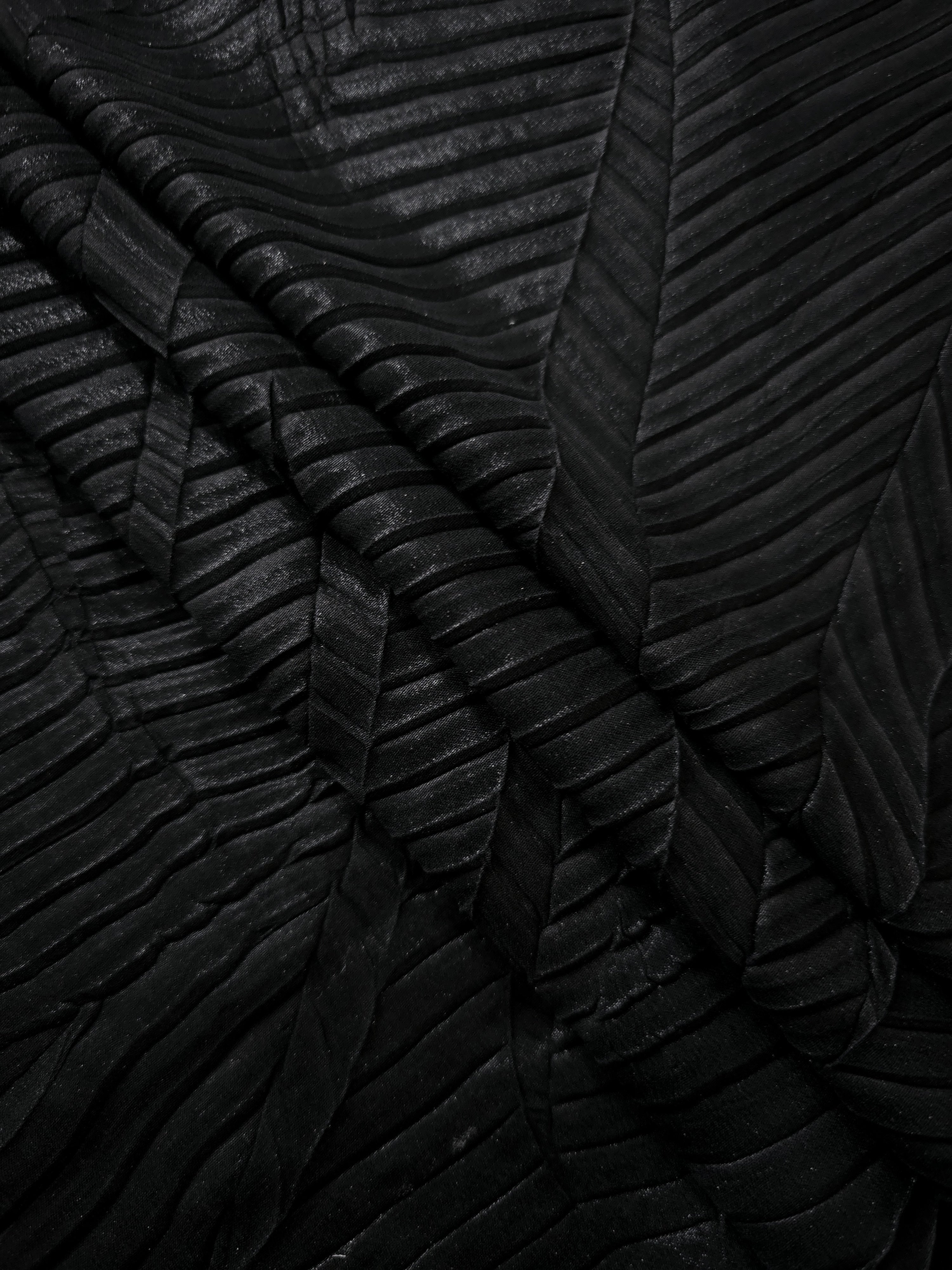Obsidian Black leaf-pattern plissé fabric in close detail, revealing the fine shimmer and dimensional pleat structure suited to bodice accents and fashion-forward blouses.