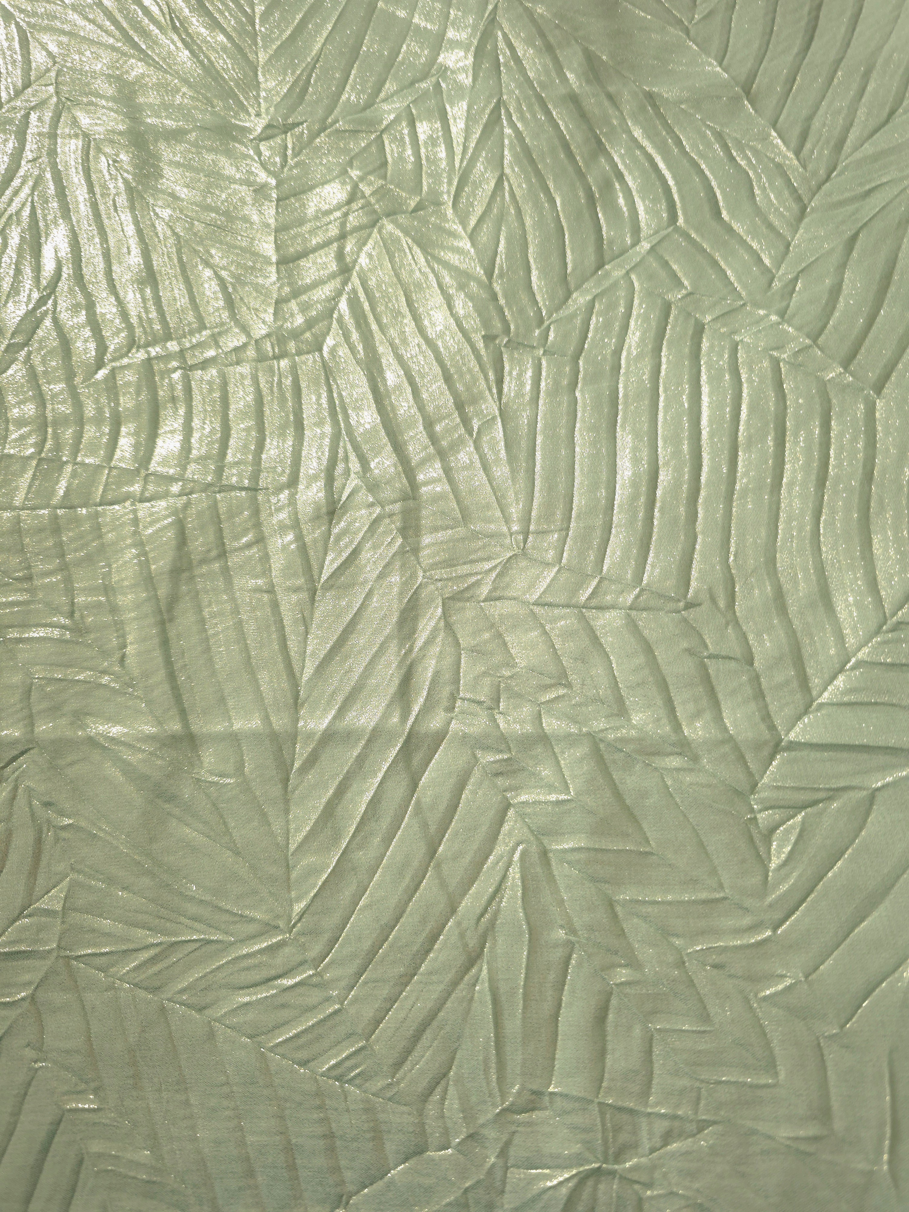 Surface detail of Pale Sage leaf-pattern plissé shimmer fabric showcases sculpted leaf-like pleats for evening clutches, garment accents and special-occasion pieces.