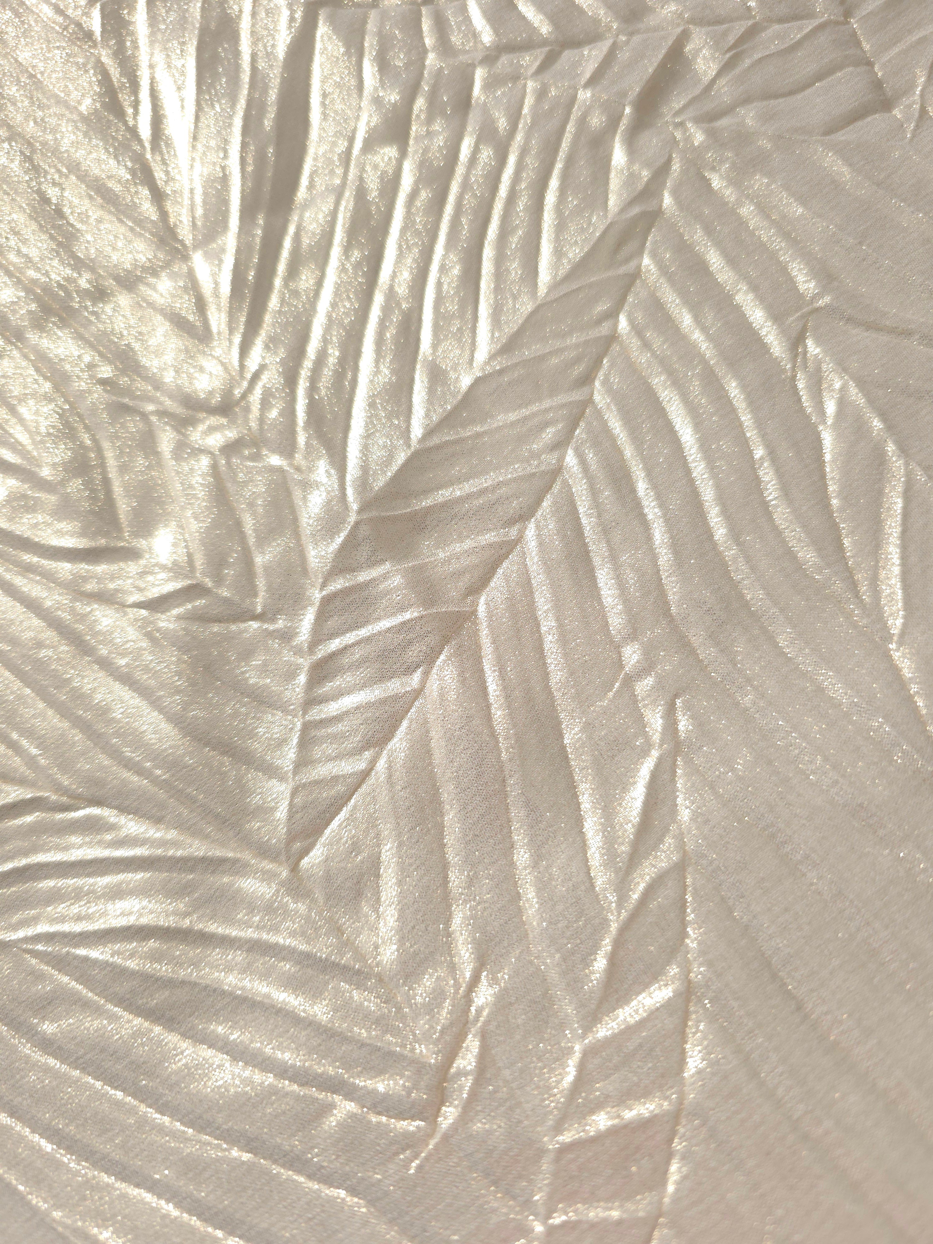Soft drape of Pearl Ivory textured shimmer plissé reveals dimensional folds and shifting reflection for jumpsuits and fluid occasionwear.