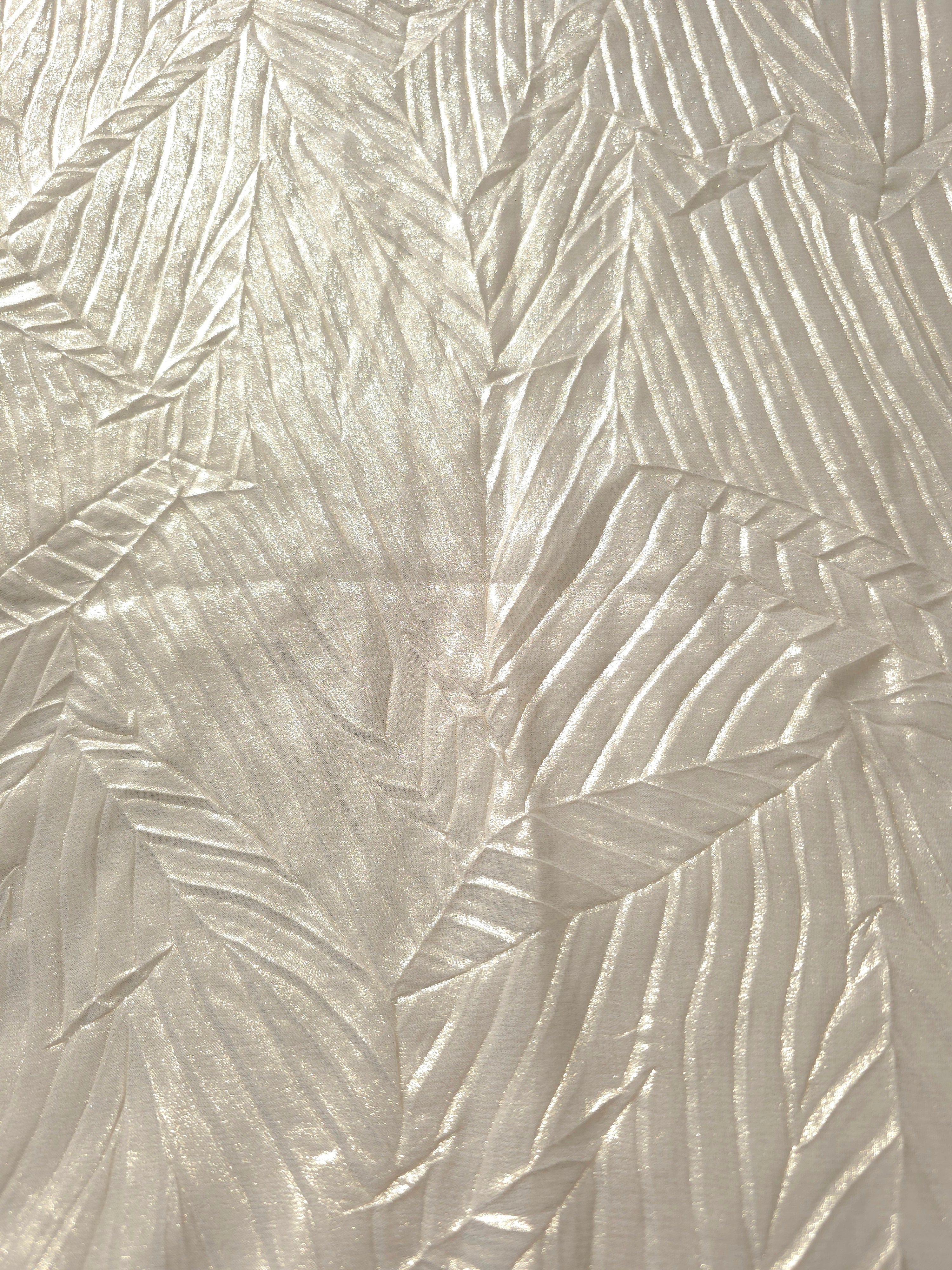 Surface detail of Pearl Ivory leaf-pattern plissé shimmer fabric showcases sculpted leaf-like pleats for evening clutches, garment accents and special-occasion pieces.