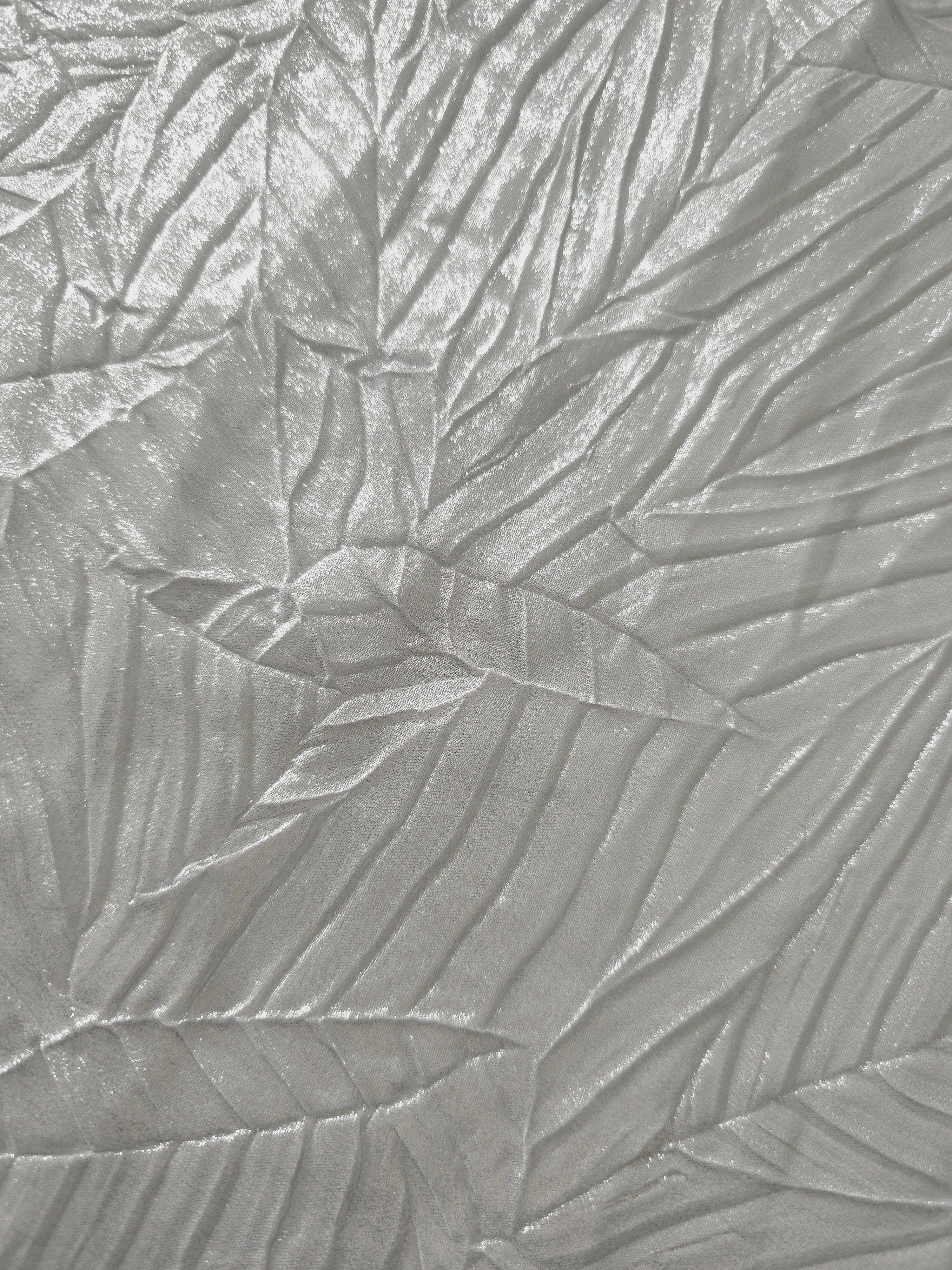 Soft drape of Pearl Silver textured shimmer plissé reveals dimensional folds and shifting reflection for jumpsuits and fluid occasionwear.