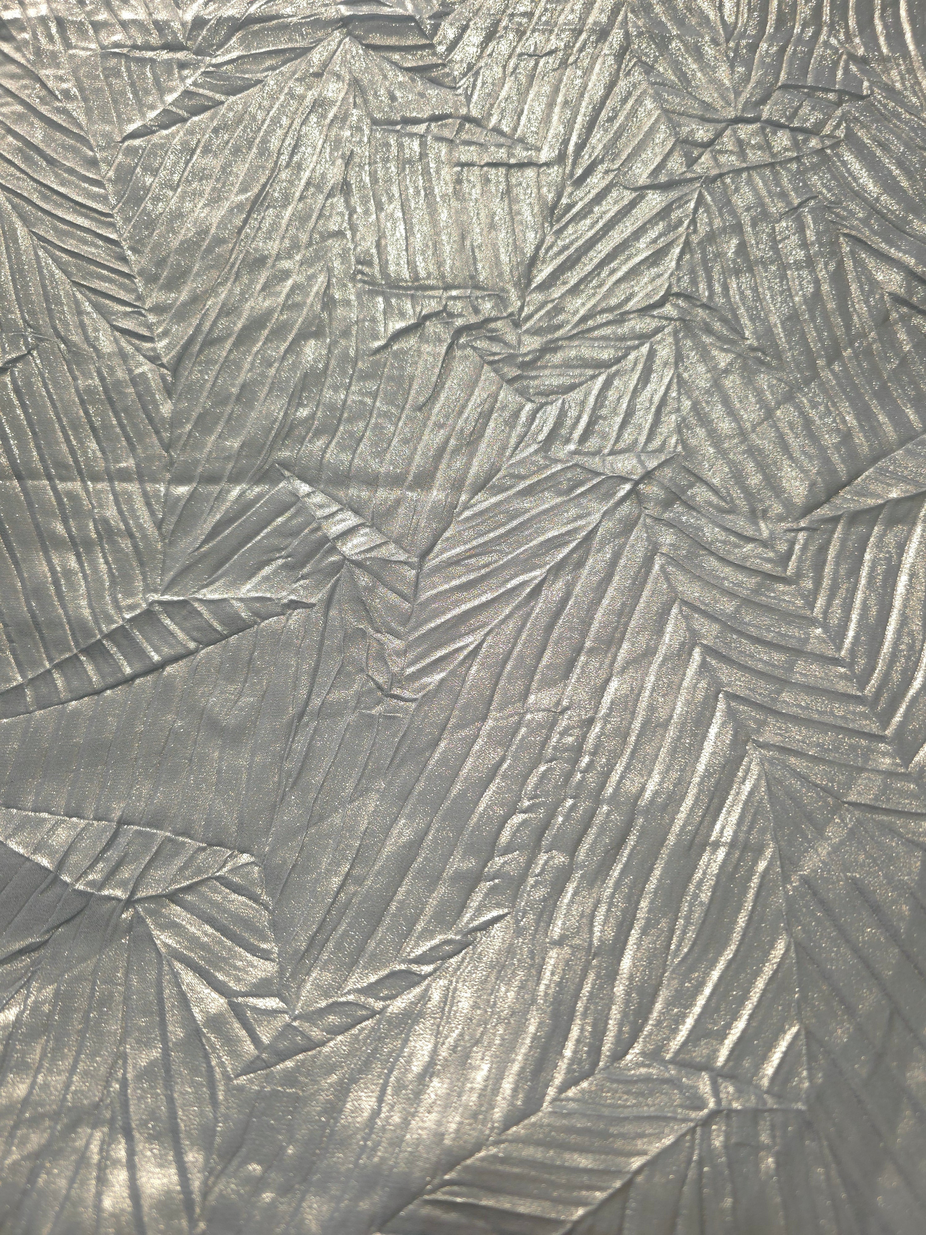 Surface detail of Pewter Gray leaf-pattern plissé shimmer fabric showcases sculpted leaf-like pleats for evening clutches, garment accents and special-occasion pieces.