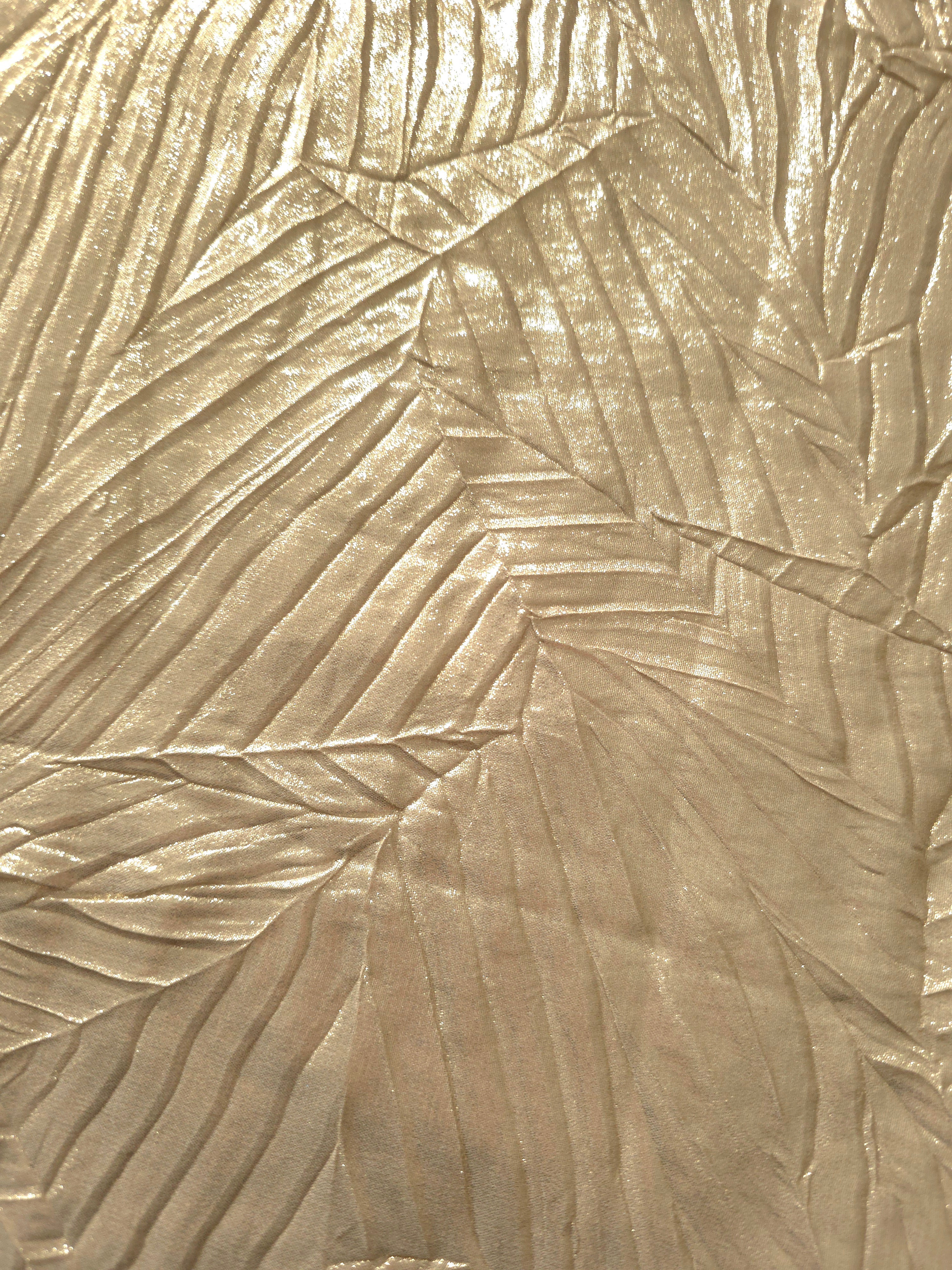 Soft drape of Soft Champagne textured shimmer plissé reveals dimensional folds and shifting reflection for jumpsuits and fluid occasionwear.