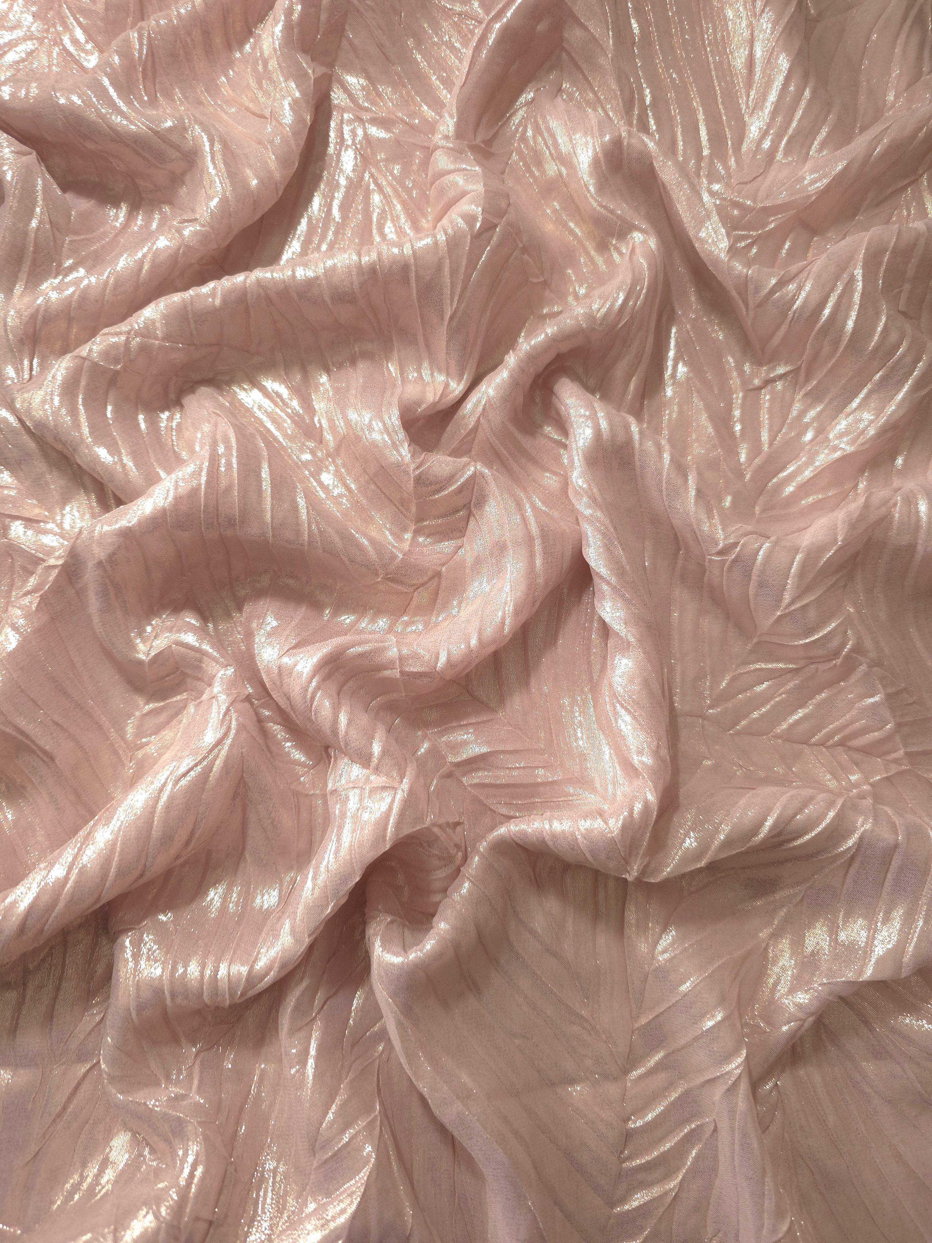 Flowing drape of Soft Pink leaf-pattern plissé shimmer fabric, showing sculpted leaf-like pleats and light-catching movement for evening gowns and flowing maxi skirts.