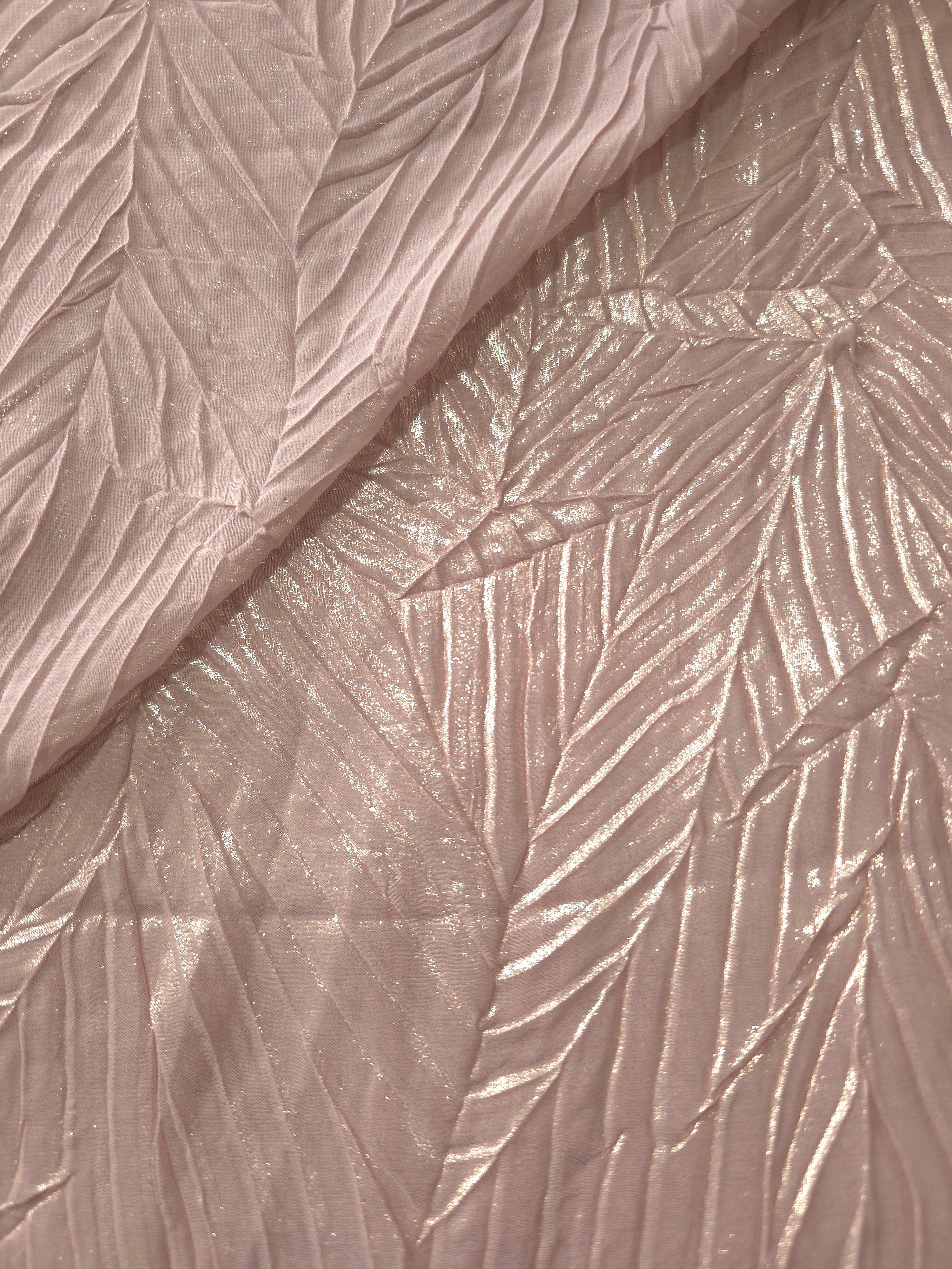 Fold detail of Soft Pink leaf-pattern plissé fabric demonstrates how the textured surface builds depth for stagewear and layered fashion details.