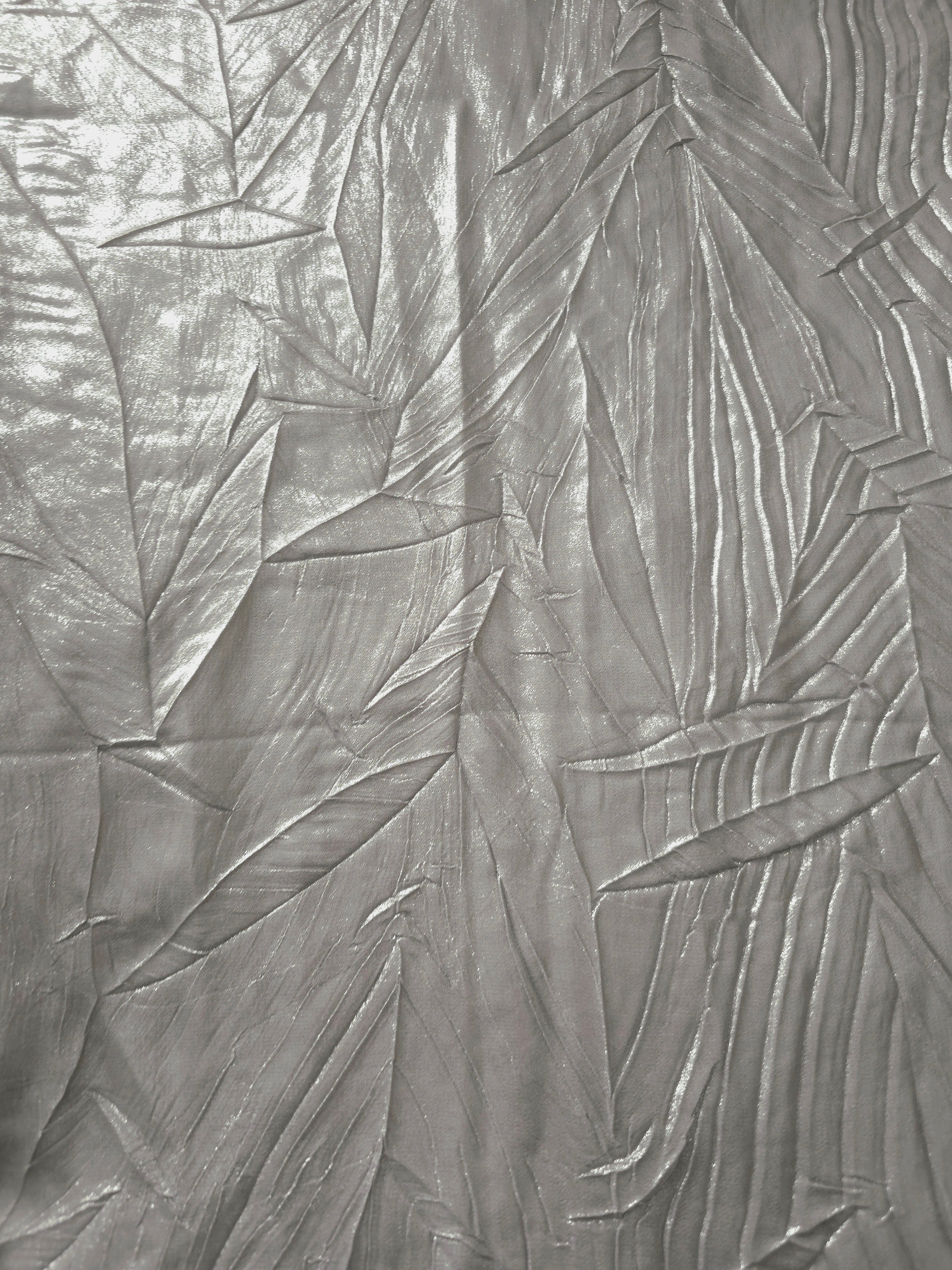 Surface detail of Steel Silver leaf-pattern plissé shimmer fabric showcases sculpted leaf-like pleats for evening clutches, garment accents and special-occasion pieces.