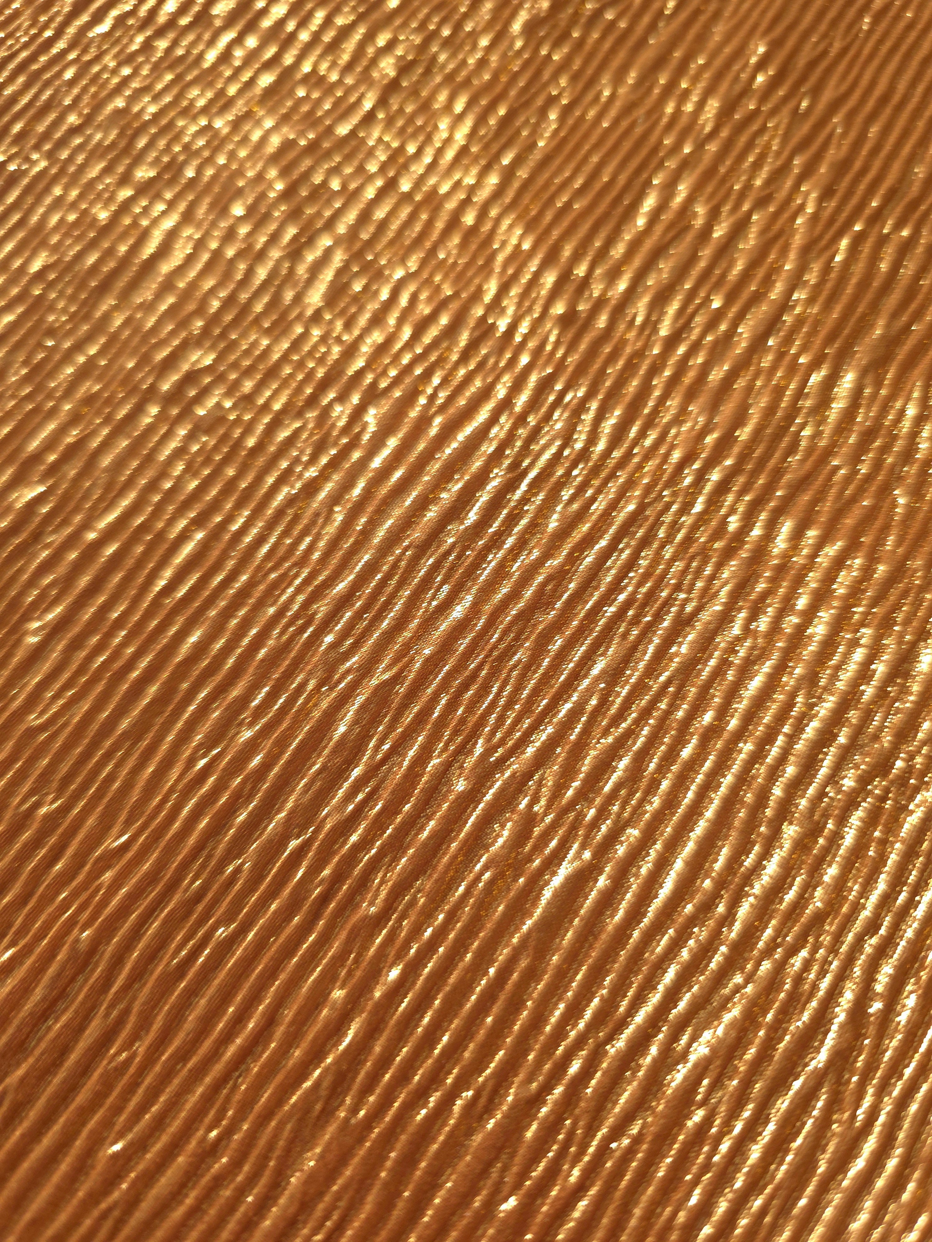 Soft drape of Burnished Copper textured shimmer plissé reveals dimensional folds and shifting reflection for formal tops and draped skirt designs.